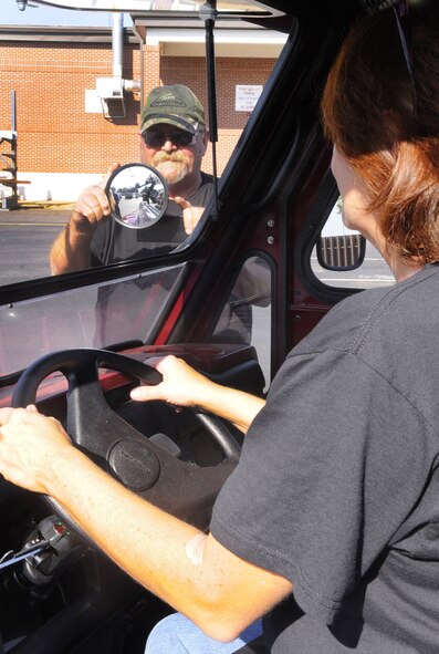 Mike Davis adjusts one of the new mirrors for Diane Lawson. U. S. Air Force photo by Sue Sapp