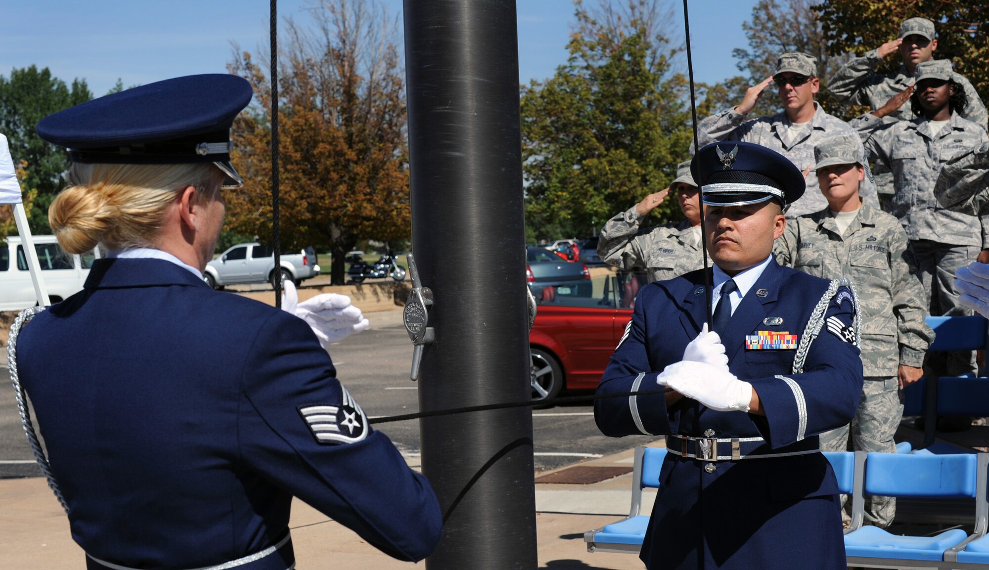 Staff Sgts. Valerie Baker (left) and Fabian Martinez, members of the ARPC honor guard, lower the POW/MIA flag during the closing ceremony of the POW/MIA vigil at ARPC on Sept. 17. During the vigil, 30 volunteers from ARPC read the names of servicemembers who are still prisoners of war or missing in action. (U.S. Air Force photo by Greg Simmonds)