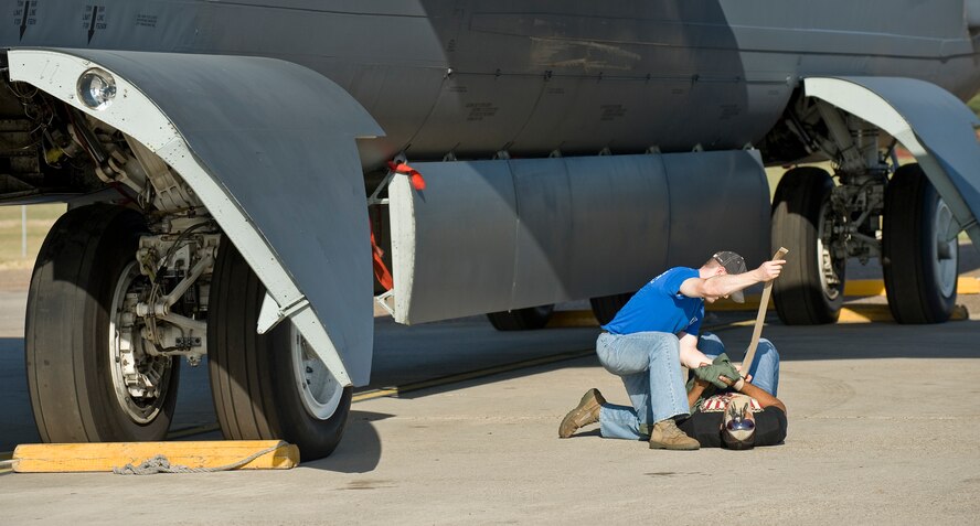 BARKSDALE AIR FORCE BASE, La. -- 1st Lt. Stephen Bonner, 2nd Security Forces Squadron, provides aid to a simulated injury during a nuclear surety exercise Sept. 22. The NSE is designed to ensure Barksdale's ability to execute nuclear operations in a safe, secure and reliable manner. (U.S. Air Force photo/Senior Airman Chad Warren) 