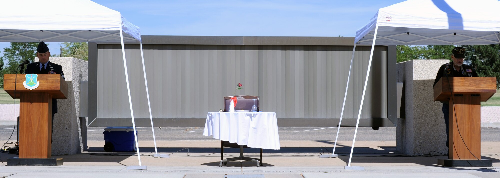 Master Sgt. Laramie Reece (left) and his father Barry Reece read the names of servicemembers who are still prisoners of war or missing in action, while the missing man table sits between them. The names were read during the Air Reserve Personnel Center's POW/MIA vigil on Sept. 17. (U.S. Air Force photo by Greg Simmonds)