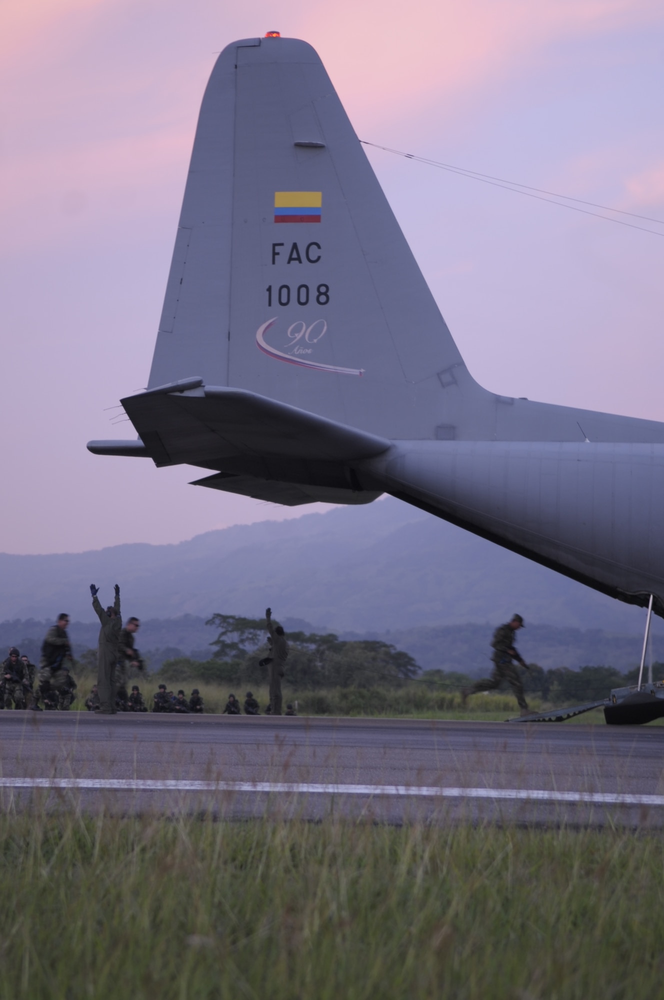 PALANQUERO AIR BASE, Colombia -- As the loadmasters give the okay, the Colombian Air Force commandos run to reboard the aircraft during an infiltration and exfiltration exercise Sept. 14 here. The exercise was the first of many during a weeklong information exchange between four Airmen from Moody’s rescue community and Colombian air force C-130 crews here.  