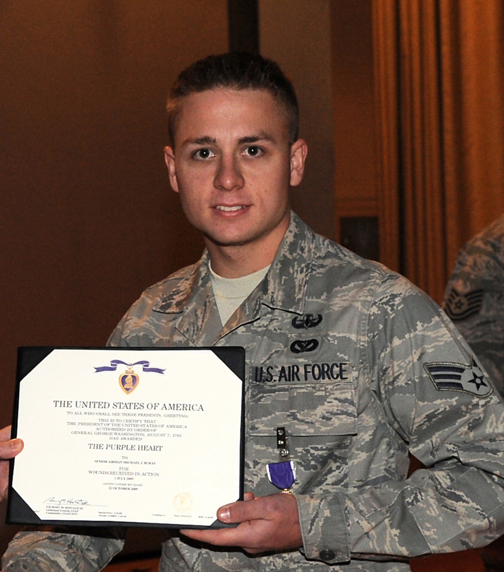 NELLIS AIR FORCE BASE, Nev.--Senior Airman Michael Buras, a 99th Civil Engineer Squadron explosive ordnance disposal journeyman, poses for a photo shortly after receiving the Purple Heart Dec. 4, 2009. Airman Buras died Sept. 21 of wounds suffered as the result of an improvised explosive device detonation in Kandahar, Afghanistan. (U.S. Air Force photo by Lawrence Crespo/Released)