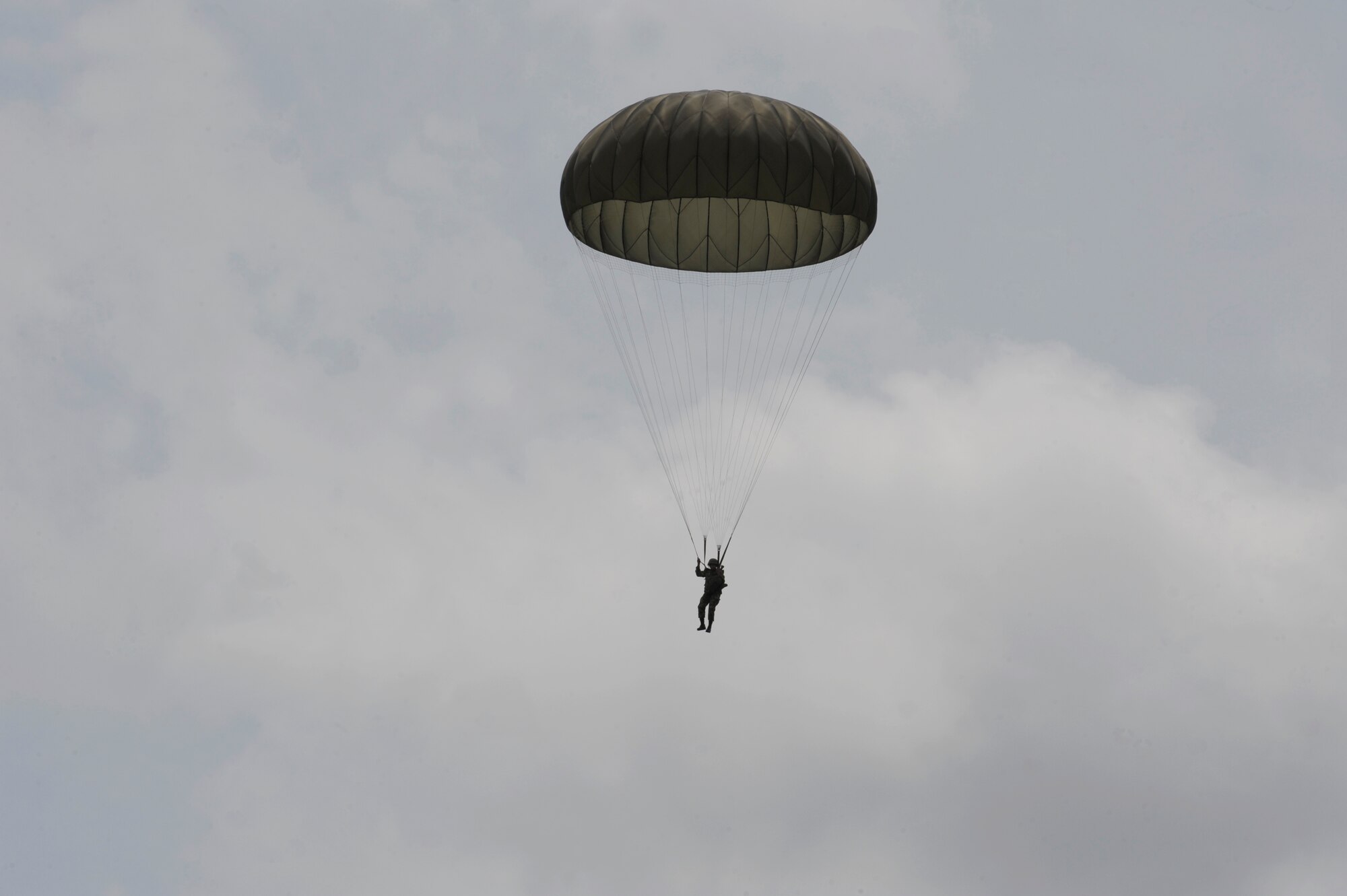 PALANQUERO AIR BASE, Colombia -- A Colombian military member parachutes to the ground after a static line jump from a Colombian C-130 Sept. 16 here.  They successfully completed three static line and high-altitude, low-opening (HALO) jumps during an exercise in which U.S. and Colombian aircrews exchanged information. 