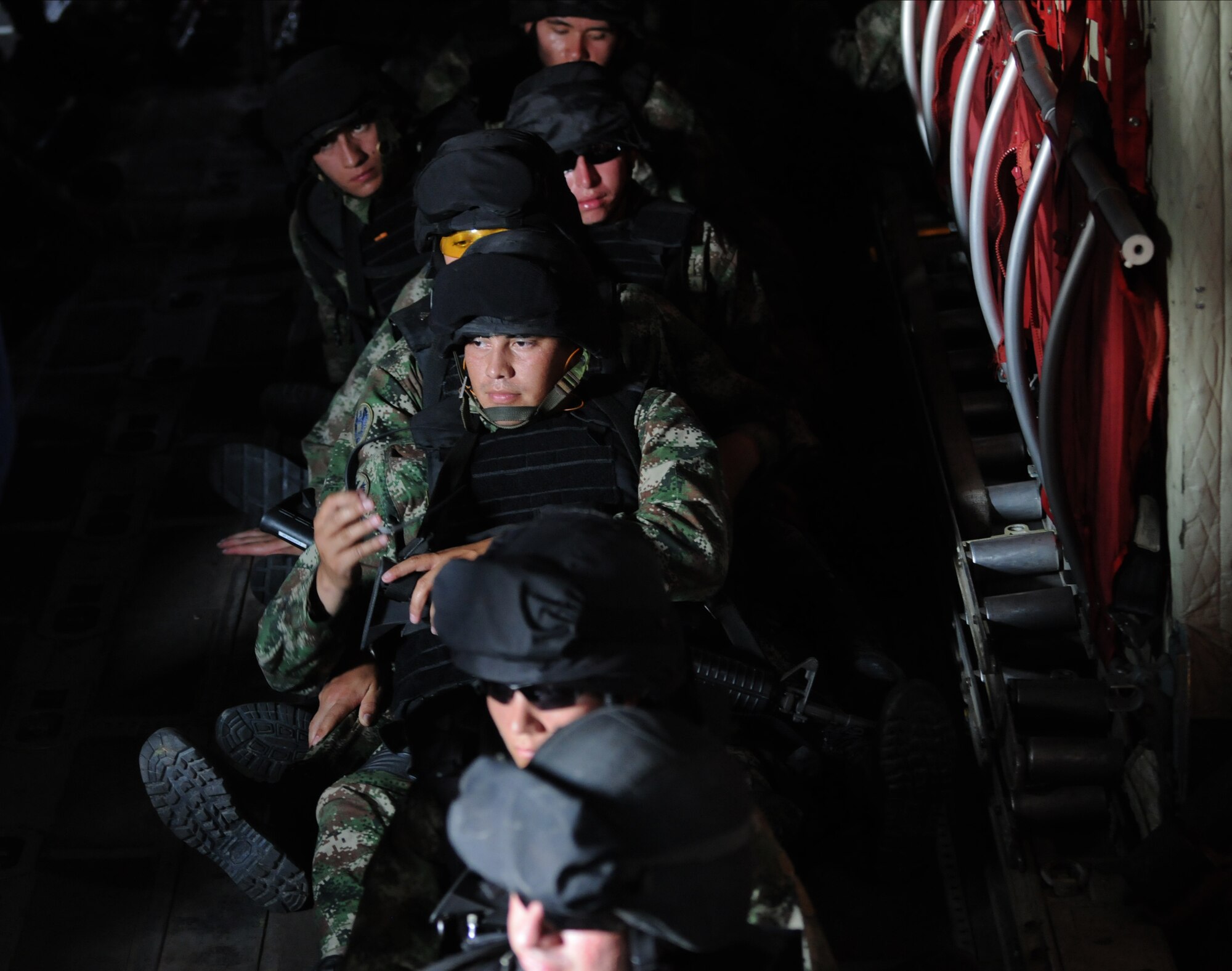 PALANQUERO AIR BASE, Colombia -- Members of the Colombian military sit in the back of a C-130 prior to a training exercise with Colombian C-130 aircrews Sept. 16 here.  During a weeklong information exchange, four Airmen from Moody Air Force Base observed and advised the Colombians on their day-to-day rescue operations such as personnel air drops, cargo drops, infiltration, and exfiltration of military and civilian personnel.  