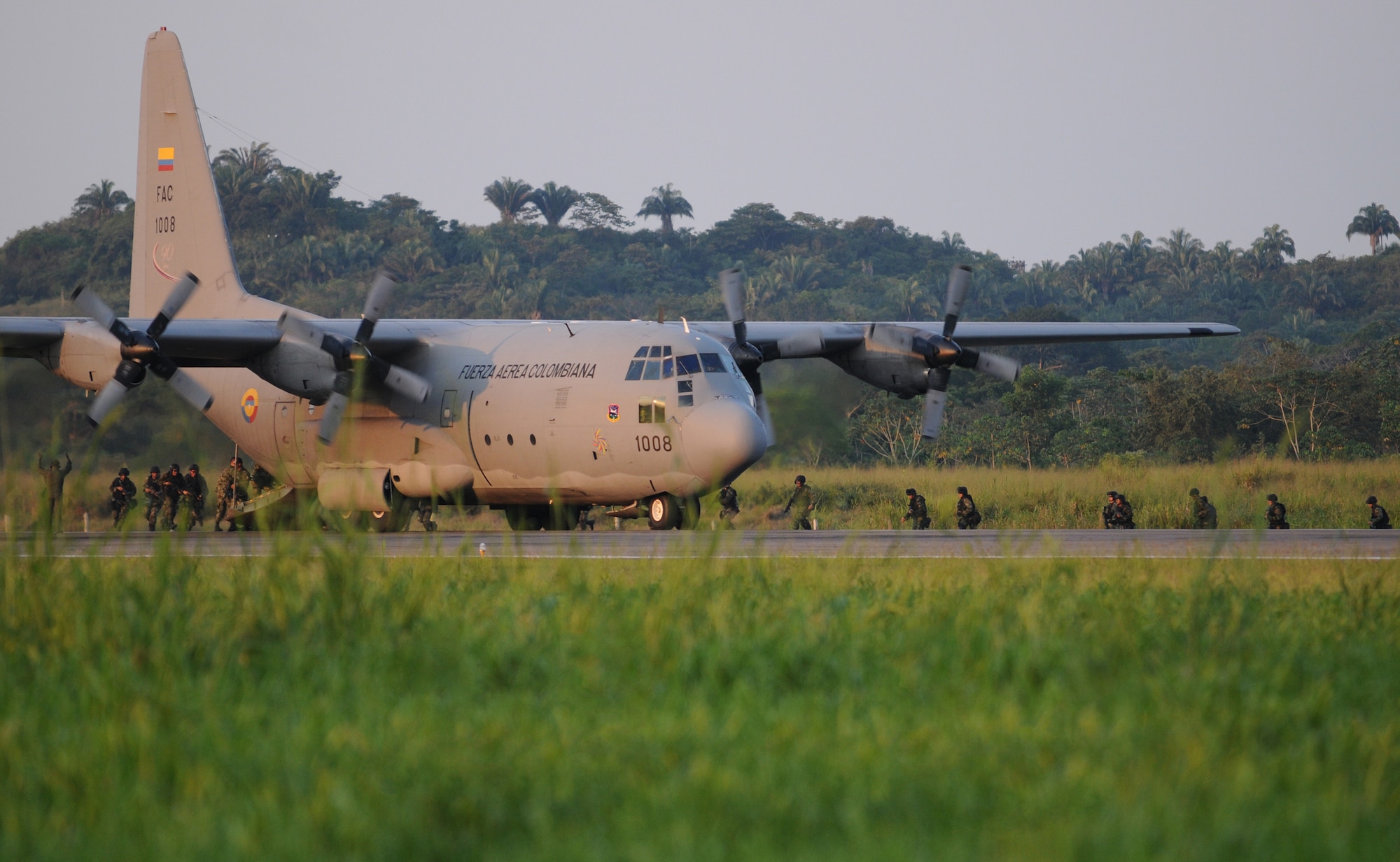 PALANQUERO AIR BASE, Colombia -- Colombian air force commandos run back to the C-130 during an infiltration and exfiltration exercise Sept. 14 here.  The exercise was one of many during a weeklong subject matter expert exchange between Airmen from Moody’s rescue community and Colombian air force C-130 crews here.  