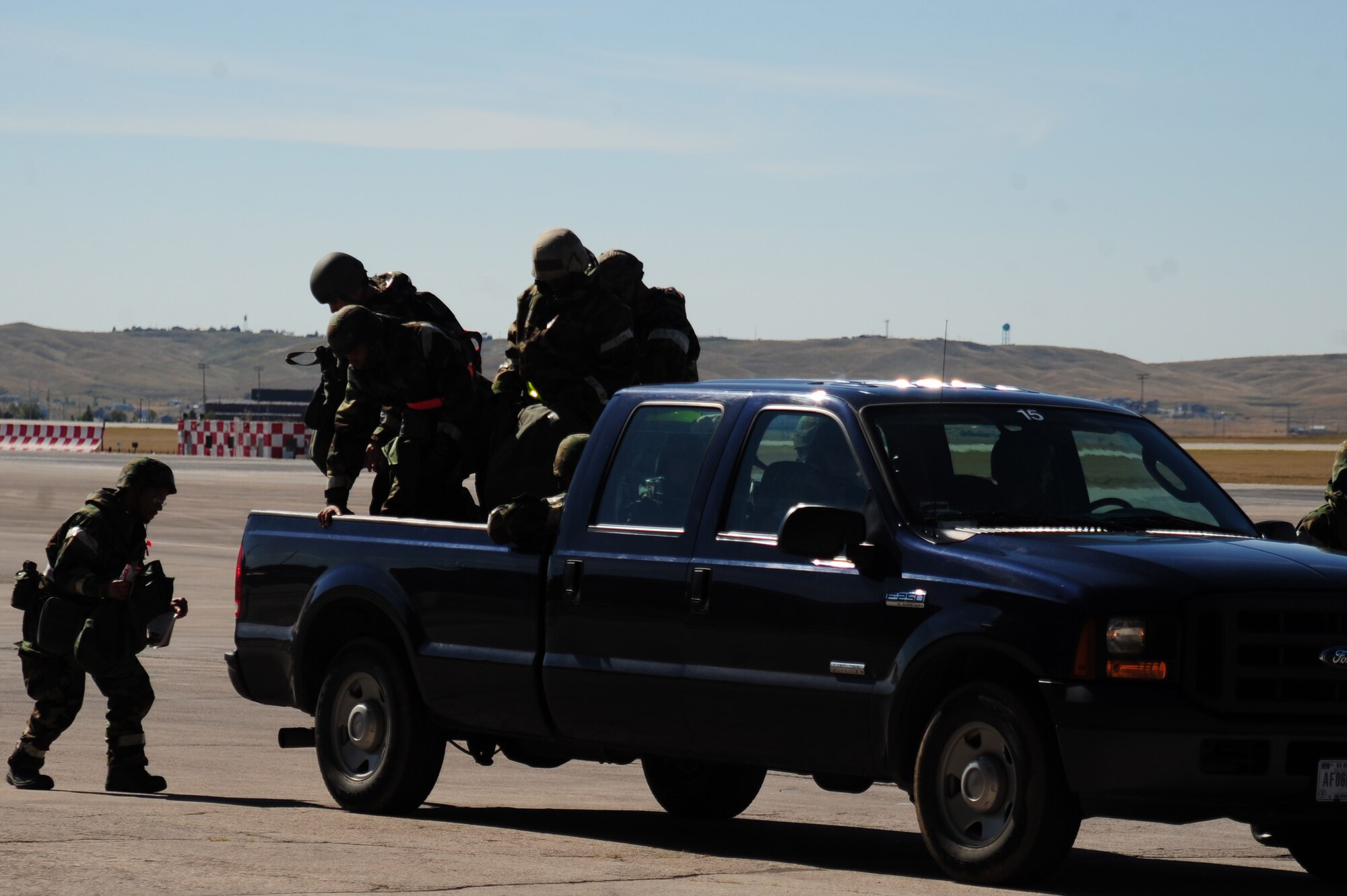 ELLSWORTH AIR FORCE BASE, S.D. –Airmen from the 28th Civil Engineer Squadron get out of a truck after being transported during a Phase II Operational Readiness Exercise, Sept. 16. The exercise tests Airmen and their abilities to operate in a simulated deployed environment. (U.S. Air Force photo/Senior Airman Corey Hook)