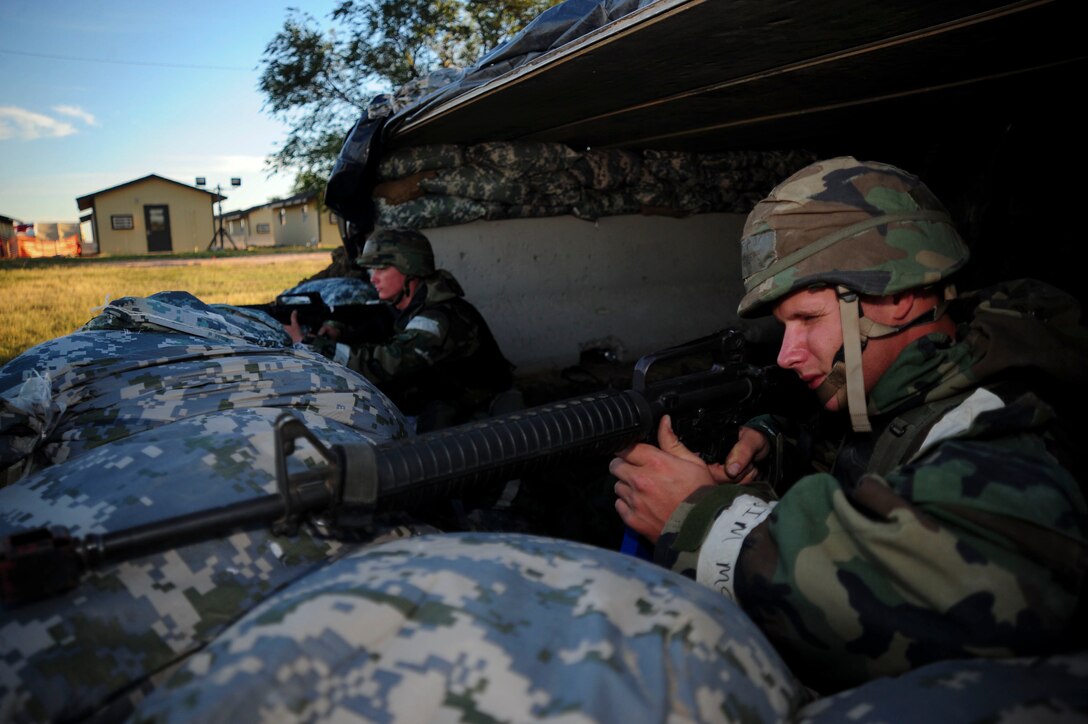 ELLSWORTH AIR FORCE BASE, S.D. – (Left) Airman 1st Class James Allen, structures apprentice and Airman 1st Class Bryan Huberty, pavements and construction operator, both from the 28th Civil Engineer Squadron, take aim in the prone position during a Phase II Operational Readiness Exercise, Sept. 16. Numerous Airmen stood guard in bunkers during the Phase II ORE ready to take action during ground attacks. (U.S. Air Force photo/Senior Airman Corey Hook)