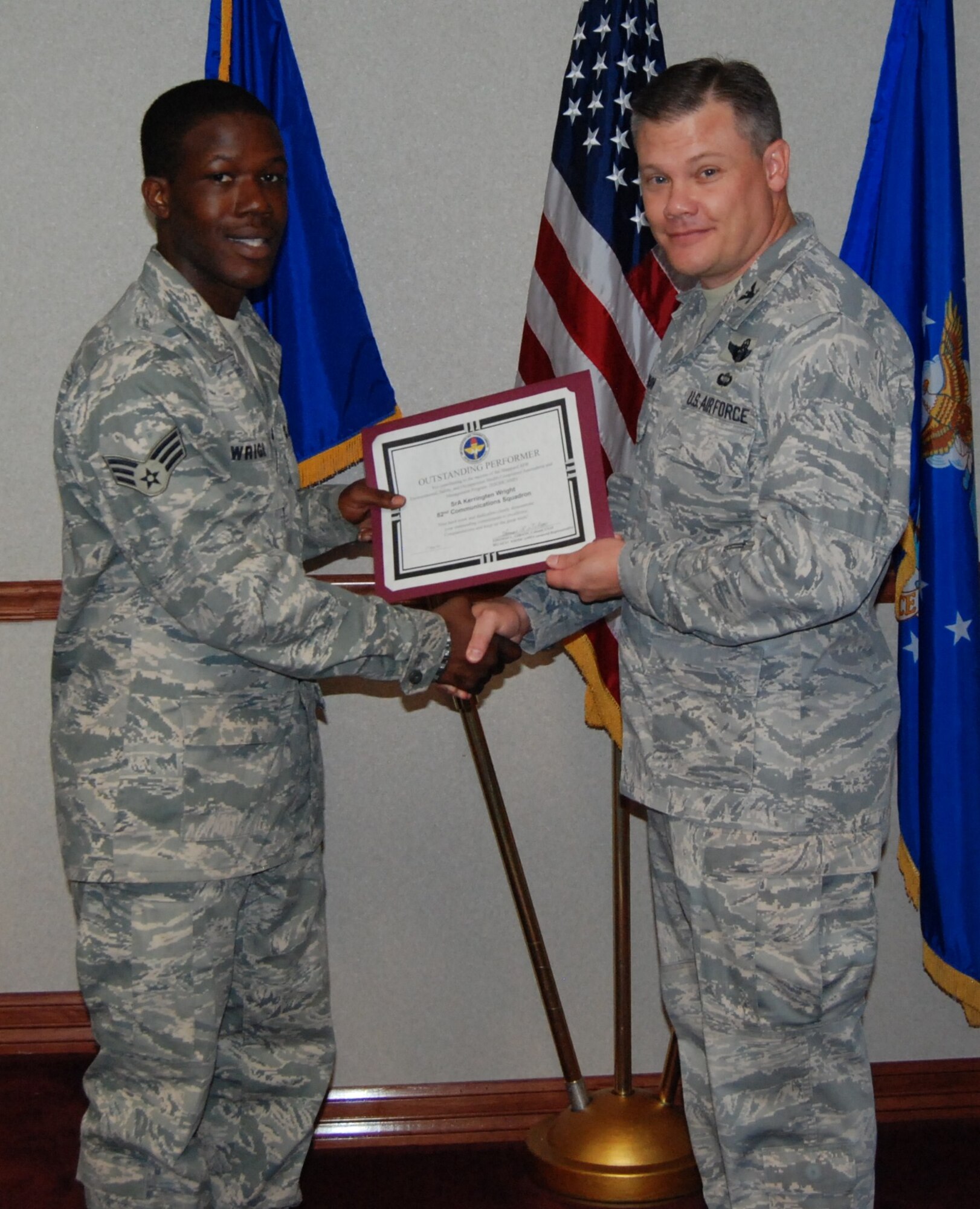 Headquarters Air Education and Training Command ESOHCAMP Command Representative, Col. Thomas Gibson, recognizes Senior Airman Kerringten Wright, 82nd Communications Squadron, with a certificate and coin for his outstanding management of the Lock Out/Tag Out program.  Other stand-out performers during the Sept.  13 – 16 environmental assessment included Staff Sgt. William O’Brien, 82nd Aerospace Medicine Squadron; Mr. Charles Berry, 82nd Logistics Squadron and Staff Sgt. Joseph Loupe, 366th Training Squadron.  (U.S. Air Force photo/Tech.  Sgt. Michele Jimenez)