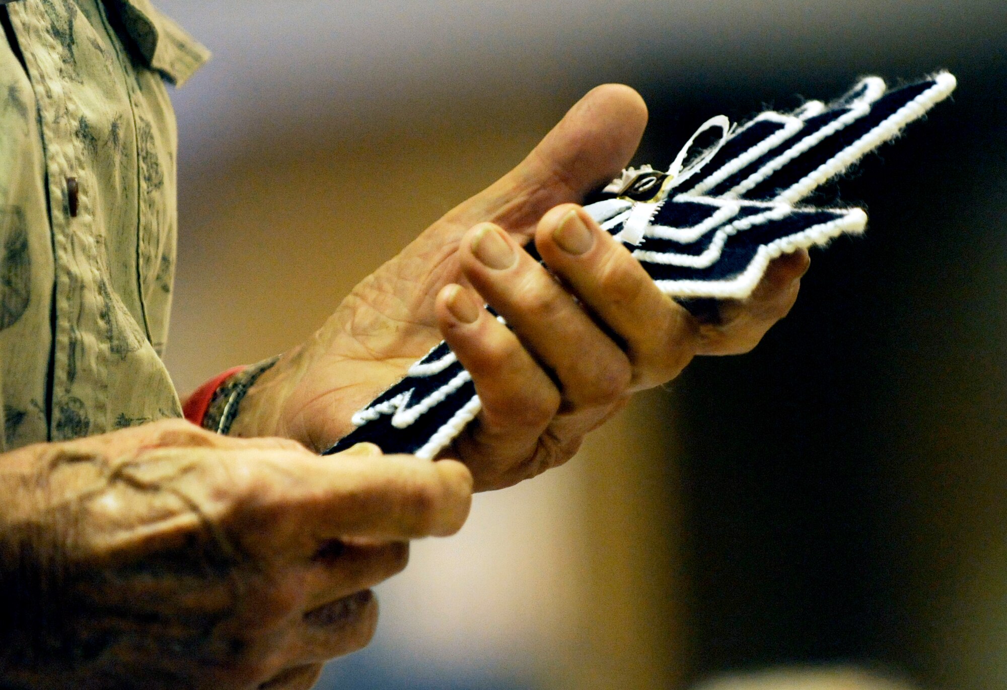 A veteran is handed a hand-sewn cross during the 19th Annual Prisoner of War/Missing in Action Recognition Ceremony hosted by the Scott POW/MIA Council Saturday at the O’Fallon, Ill., VFW Post No. 805.  The cross represents those still missing or captured and it served as a memento for those who attended the ceremony. The event was attended by approximately 300 people and included a barbeque. (U.S. Air Force photo/ Staff Sgt. Ryan Crane)