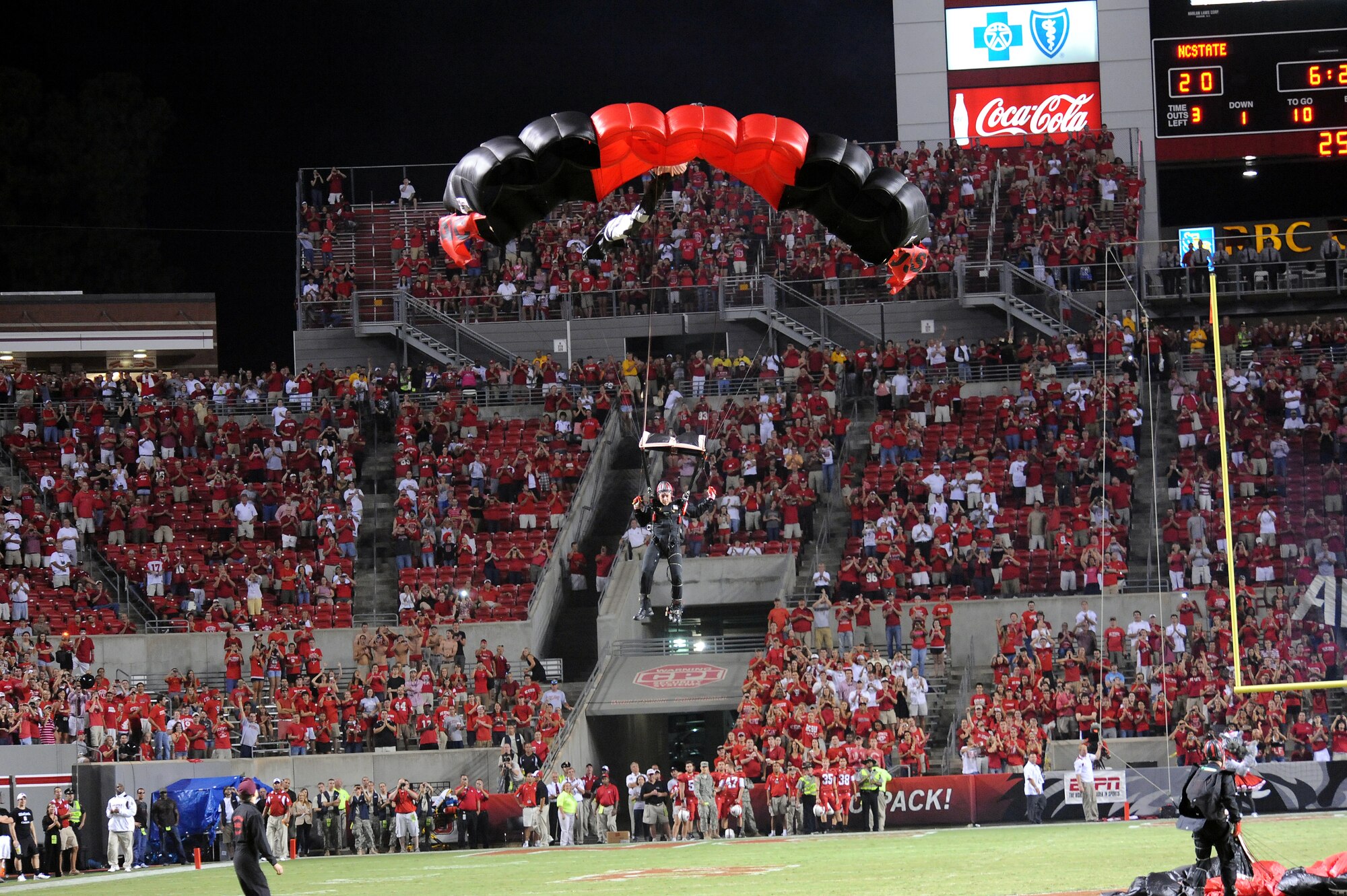 RALEIGH, N.C. – Army Staff Sgt. Kevin Haddon glides his parachute for his 1,140th free-fall landing onto the field at Carter-Finley Stadium in Raleigh Sept. 16, 2010.  The Fort Hood paratroopers parachute display took place during half-time at the N.C. State Military Appreciation Day football game against the Cincinnati Bearcats.  Sergeant Haddon, a special forces engineer stationed at Fort Bragg, hails from Mt. Hood, Ore. (U.S. Air Force photo/Master Sgt. Brandt Smith)  