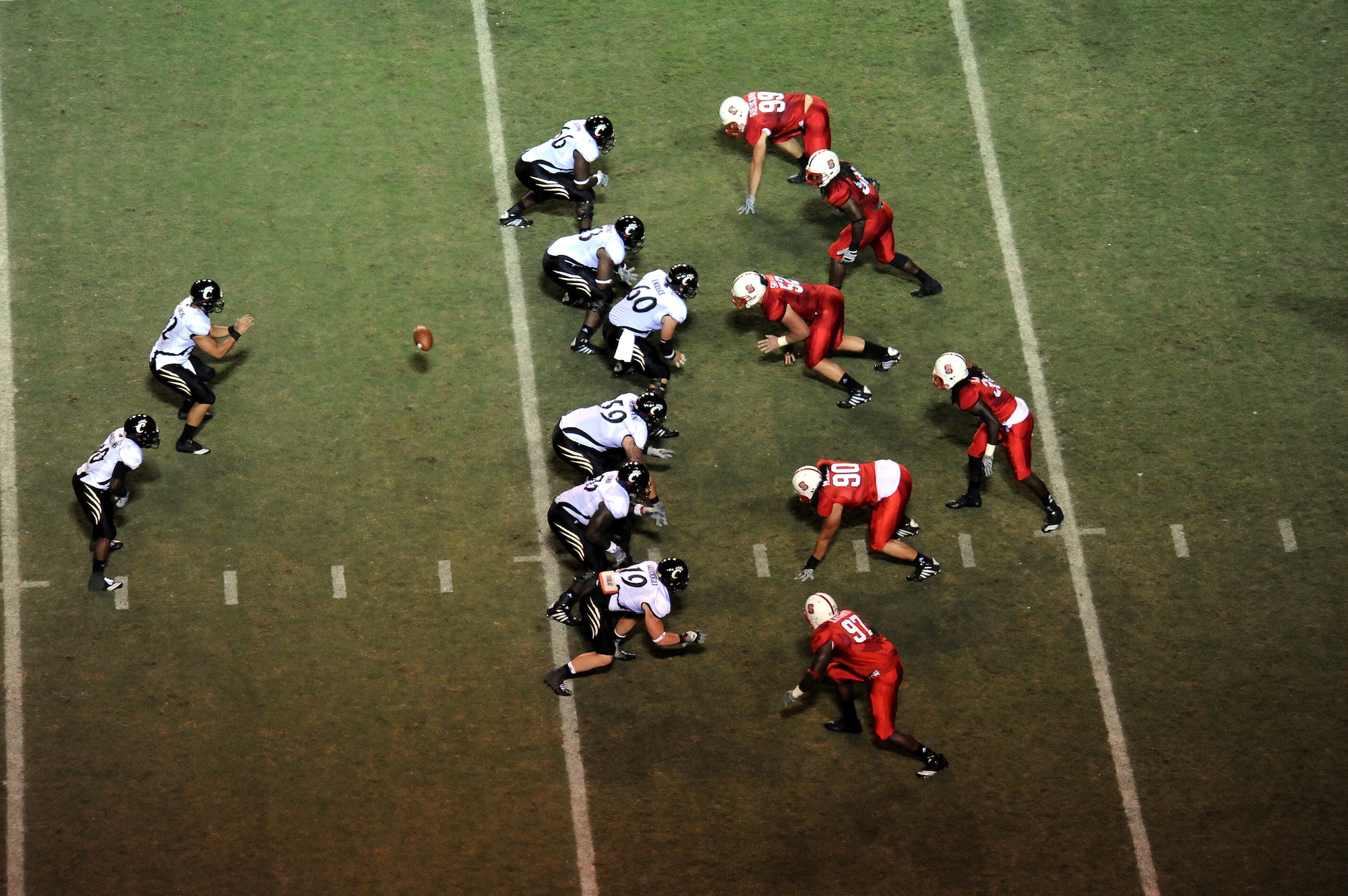 RALEIGH, N.C. – University of Cincinnati Bearcat center Jason Kelce, # 60, hikes the football to quarterback Zach Collaros, # 12, during a military appreciation night Sept. 16, 2010.  The Bearcats played the N.C. State Wolfpack at Carter-Finley Stadium.  (U.S. Air Force photo/Master Sgt. Brandt Smith)