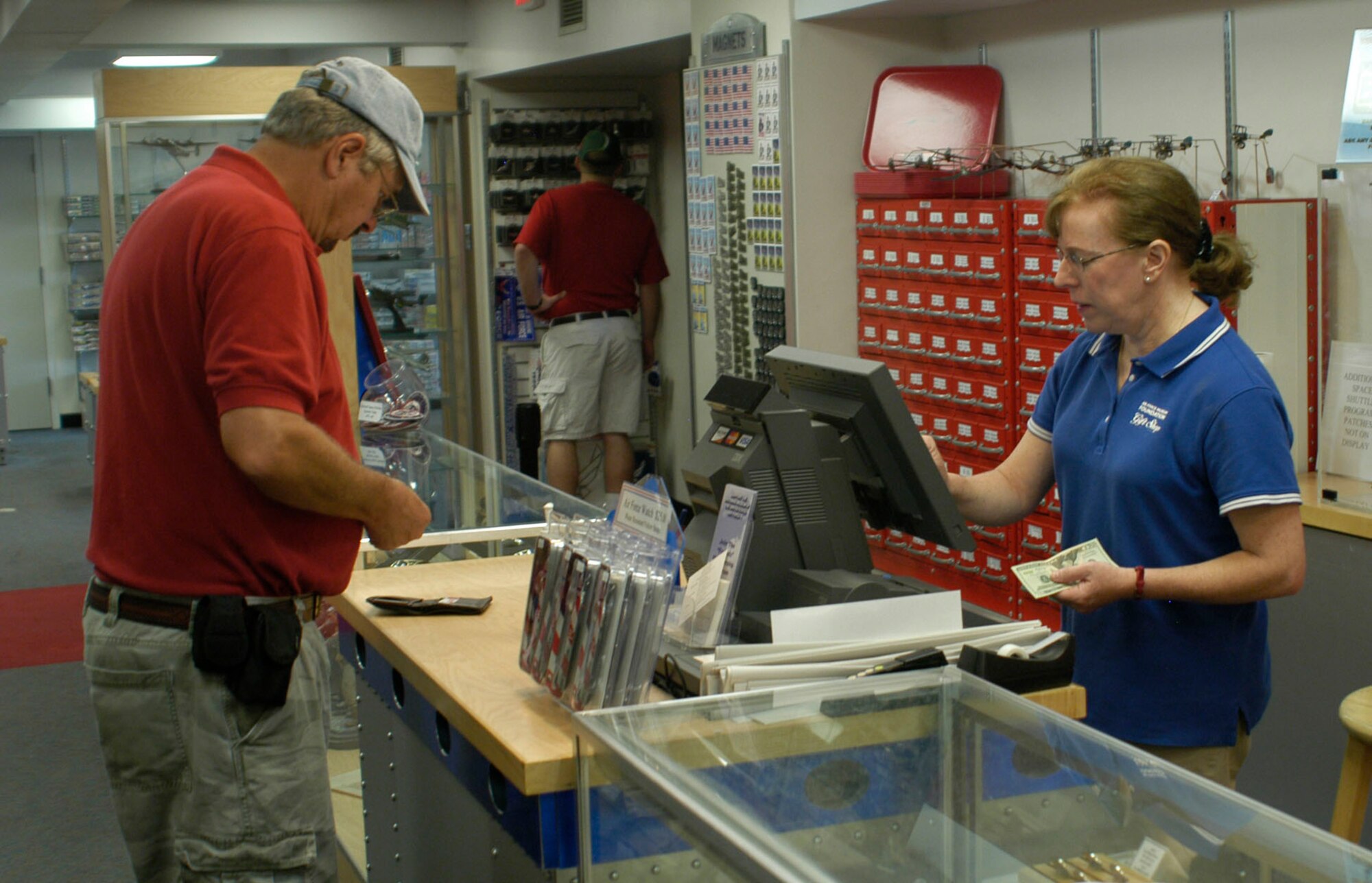 DAYTON, Ohio -- Air Force Museum Foundation employee Ann Uhlenhake (right) working in the gift shop at the National Museum of the U.S. Air Force. Uhlenhake, who is also a retired Air Force nurse, helped administer CPR to save the life of a recent museum visitor.  (U.S. Air Force Photo)  