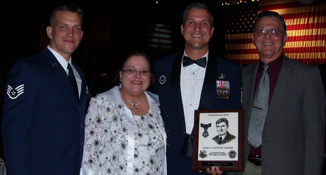 Master Sgt. William Catts (second from right) and his family displays the John Levitow Award he earned during the Air Force Senior NCO Academy graduation Sept. 14 at Maxwell-Gunter Air Force Base, Ala.  (Left to right) Staff Sgt. Robert Catts, brother; Annette Catts, mother; and retired Major Bill Catts, father;  were all present as Sergeant Catts, 364th Training Squadron flight chief of telecommunications flight, won his third John Levitow Award.  He earned the award during Airman Leadership School and the NCO Academy.  (U.S. Air Force courtesy photo)