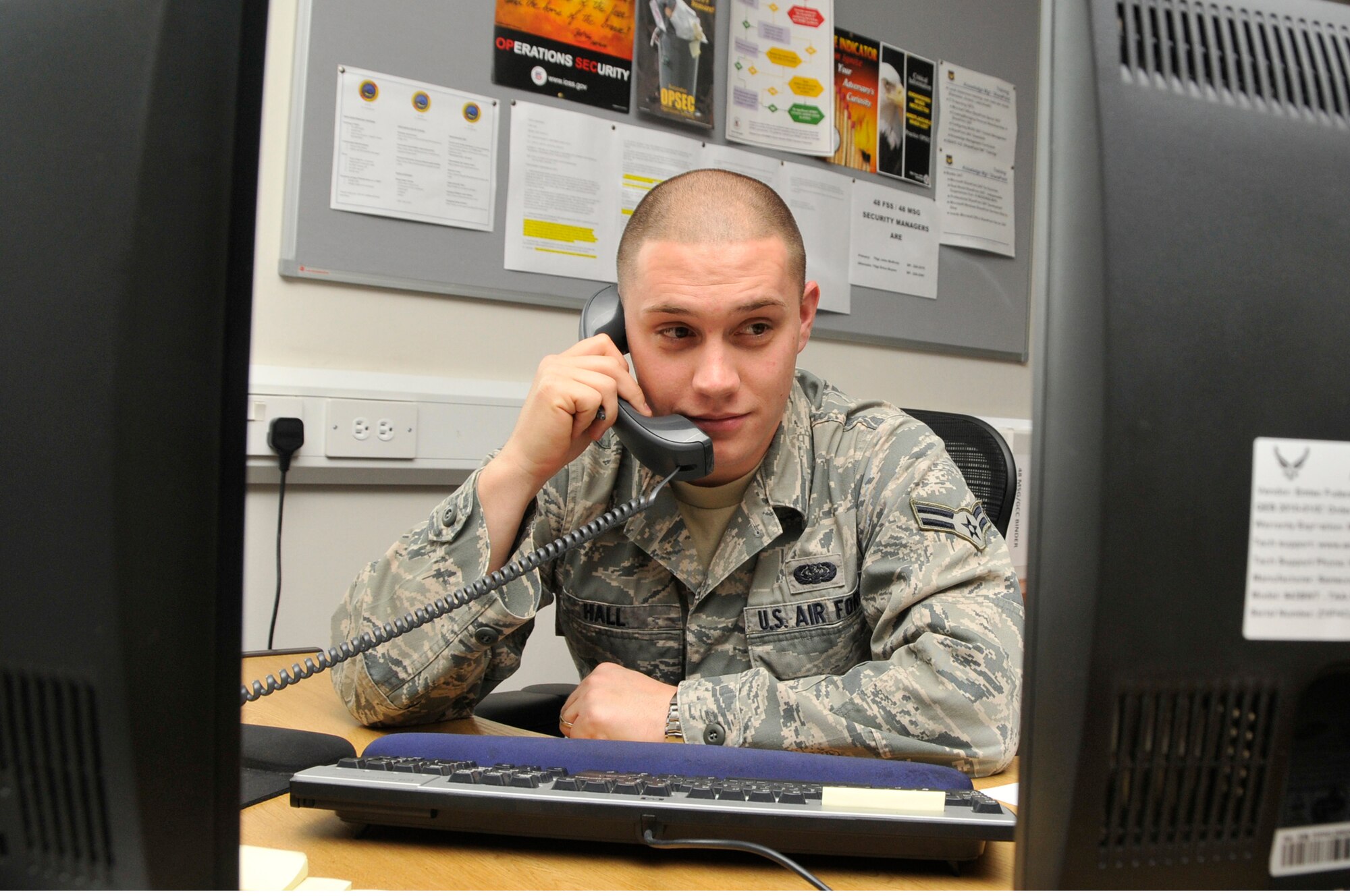 Airman 1st Class Christopher Hall, 48th Mission Support Group knowledge operations management, answers a customers inquiry on the phone Sept. 22. Airman Hall was nominated for a Liberty Spotlight because he displays the core value of 'Excellence in All We Do'. (U.S. Air Force photo/Airman 1st Class Eboni Knox)