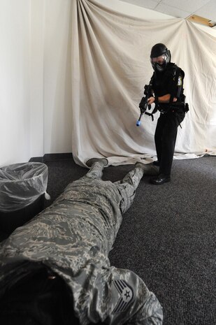 Officer John Kimbler subdues an aggressor during a mock hostile situation during the active shooter training exercise on Joint Base Charleston, S.C., Sept. 22, 2010. The AST exercise was a joint operation between both Air Force and Navy personnel and tested the deployment of rapid intervention techniques. Mr. Kimbler is a security forces officer with the 628th Security Forces Squadron. (U.S. Air Force photo by James M. Bowman/released)