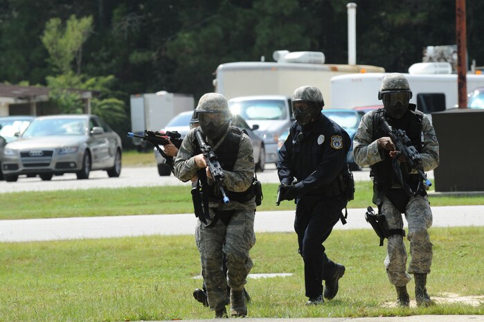 Members of the 628th Security Forces Squadron respond to an aggressor during a mock hostile situation during the active shooter training exercise on Joint Base Charleston, S.C., Sept. 22, 2010. The AST exercise prepares first responders on how to react to a hostile situation. (U.S. Air Force photo by James M. Bowman/released)
