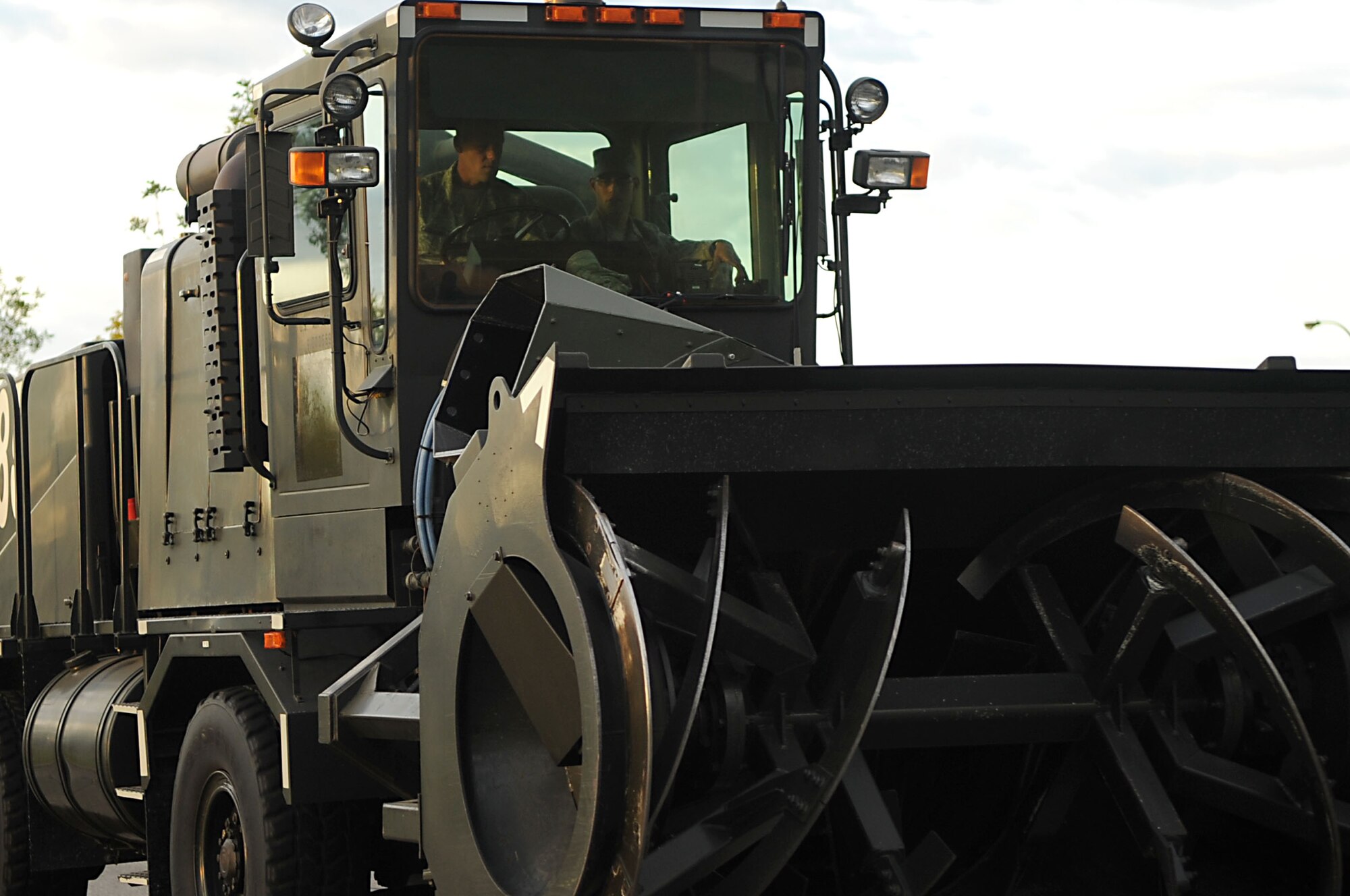 Chief Master Sgt. David Carlson, 319th Air Refueling Wing command chief, drives a piece of snow removal equipment during the 319th ARW Snow Parade Sept. 22 through Grand Forks Air Force Base. The parade allows base personnel to see the snow removal equipment before the first snow fall.  (U.S. Air Force photo by Senior Airman Amanda N. Stencil)