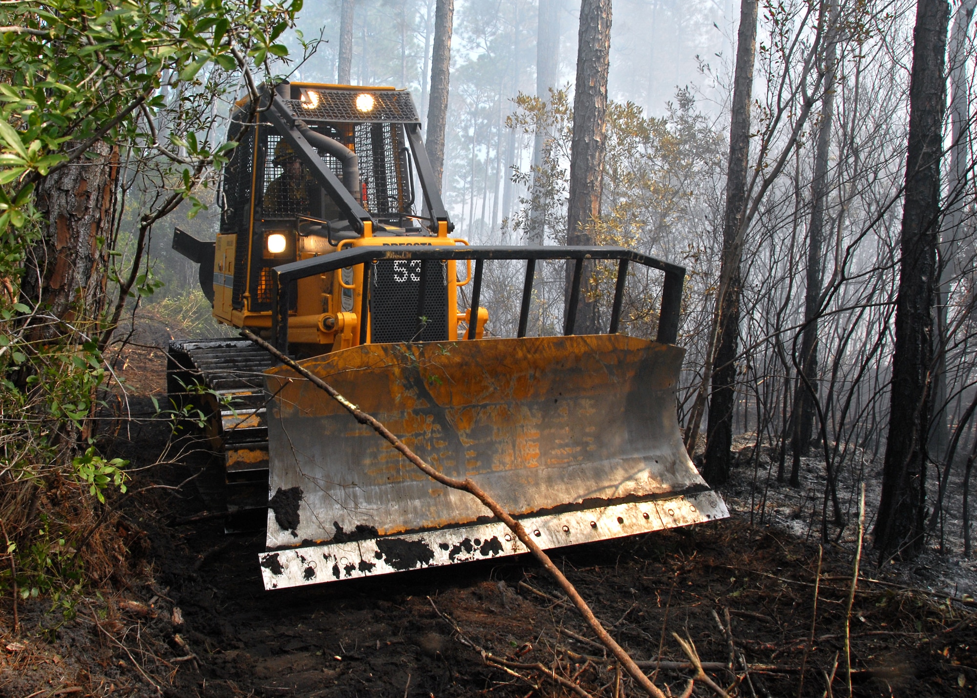 Tom Murrie, Jackson Guard wildland firefighter, creates a firebreak in the forest to keep the fire  from moving any further after it had burned approximately 90 acres of the Eglin Air Force Base range Sept. 21.  The still smoldering fire was determined to be human-caused and is under investigation.  (U.S. Air Force photo/Samuel King Jr.)  