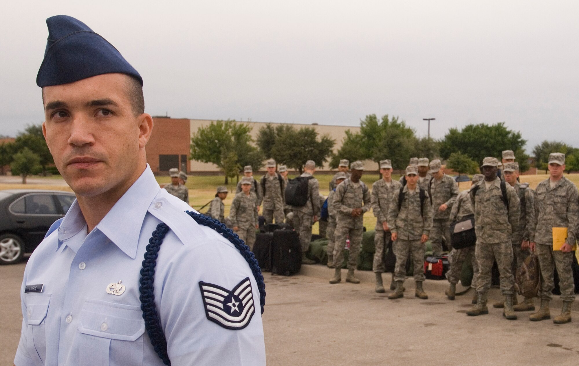 GOODFELLOW AIR FORCE BASE, Texas - Tech. Sgt. Richard Lingle, 312th Training Squadron Military Training Leader, waits for Airmen fresh from Basic Military Training at Lackland Air Force Base in San Antonio to disembark from a bus after arriving here for technical training Sept. 20.  MTL’s are a key part of an Airman’s military training. The Air Education and Training Command Special Duty Team visited Goodfellow Tuesday and spoke about special duty an Air Force Recruiter, Military Training Instructor and Military Training Leader.  Air Force members who may have missed the team’s visit can contact Master Sgt. Kenneth Guise at (325) 654-3589, or stop by building 901 for more information. (U.S. Air Force photo/Master Sgt. Randy Mallard)