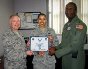MINOT AIR FORCE BASE, N.D. -- Col. Ferdinand Stoss, 91st Missile Wing commander, and Lt. Col. Kelvin Townsend, 91 Operations Support Squadron commander, present Senior Airman Destiny Bellamy, 91st OSS store room accountant, with her below-the-zone certificate and stripes here Sept. 9. Airman Bellamy was a missile field chef responsible for preparing meals at the 91st MW's missile alert facilities for launch control officers and support personnel deployed across Minot's 8,500 square mile missile range in Northwest North Dakota. Airman Bellamy is an integral member of Air Force Global Strike Command. (Courtesy photo)