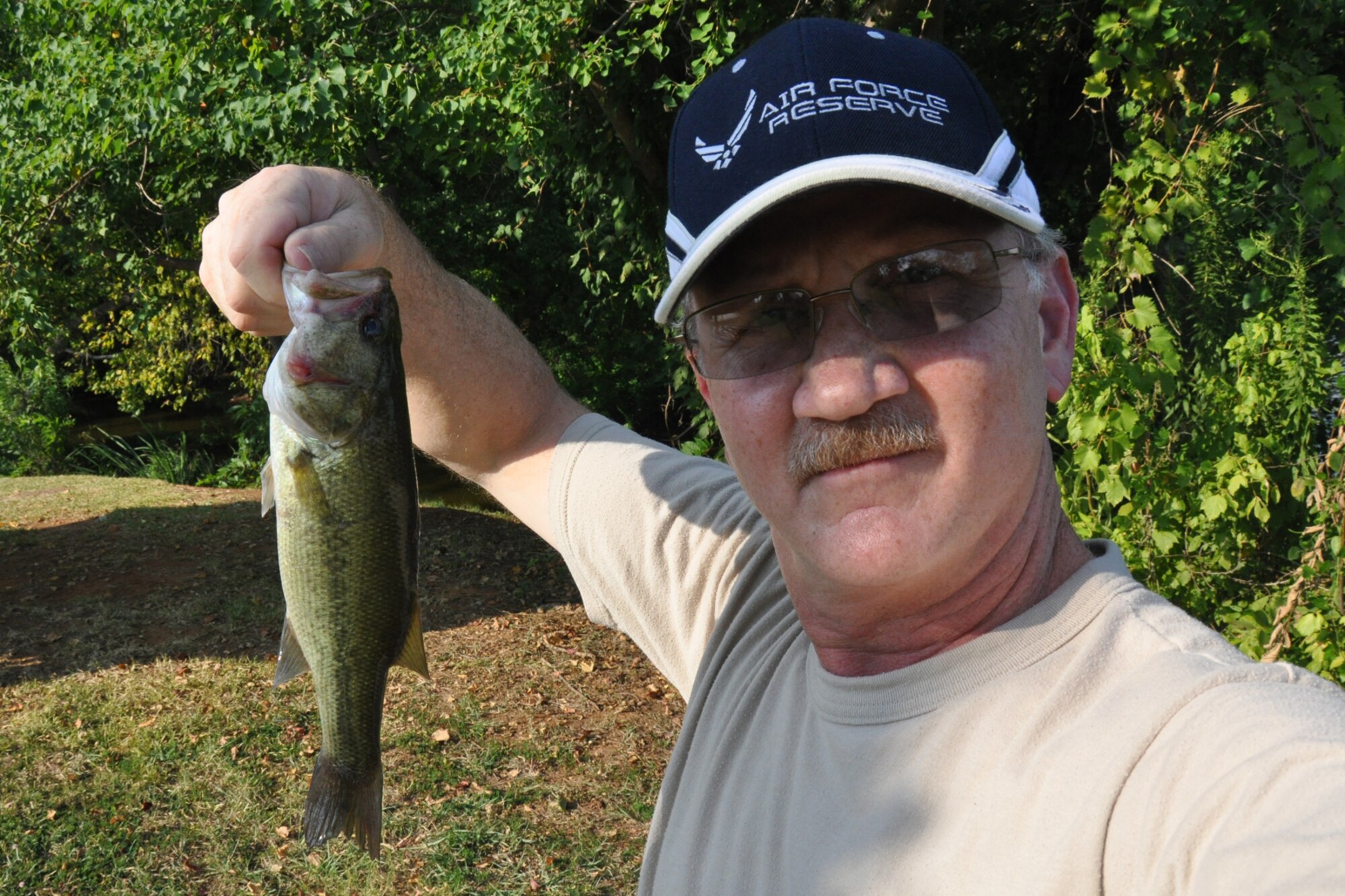 Jeff Walston, a public affairs technician with the 917th Wing at Barksdale Air Force Base, La., holds a bass he caught at a Shreveport lake Sept. 17, 2010. Walston has been practicing catch-and-release fishing for most of his life, thanks to lessons learned more than 40 years ago from his grandfather. But, he could never say he’d ever caught a fish again, after he had personally released it, until now. As it turns out, he had caught this same fish two days before. (Courtesy photo)