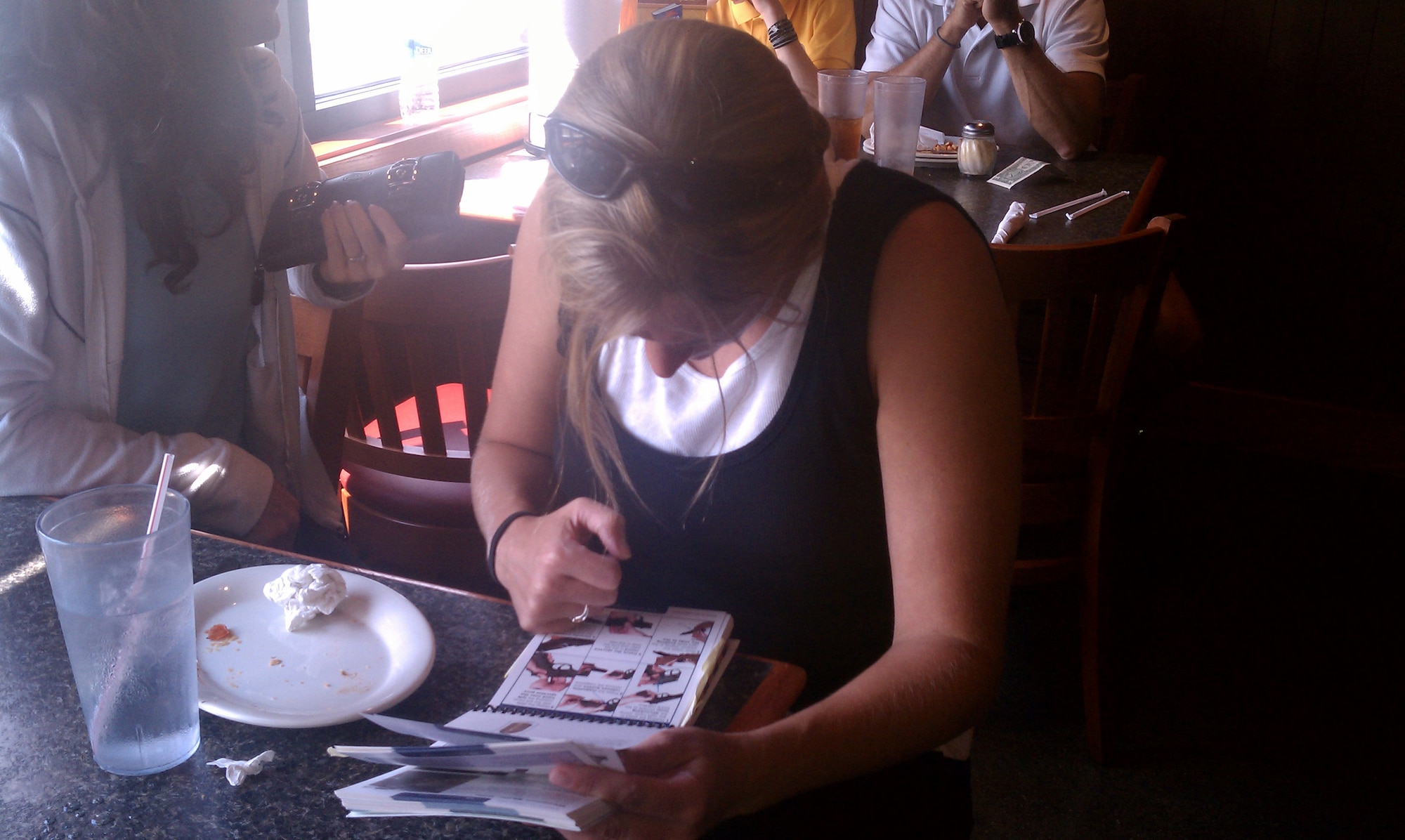 Maj. Shannon Mann, 916th Public Affairs, reads her Airman's Manual while at a rest stop area en route to the Air Force Marathon. Airmen from the 916ARW and 4FW are preparing for an inspection exercise following the Dayton race. (USAF photo by MSgt. Wendy Lopedote, 916ARW/PA)