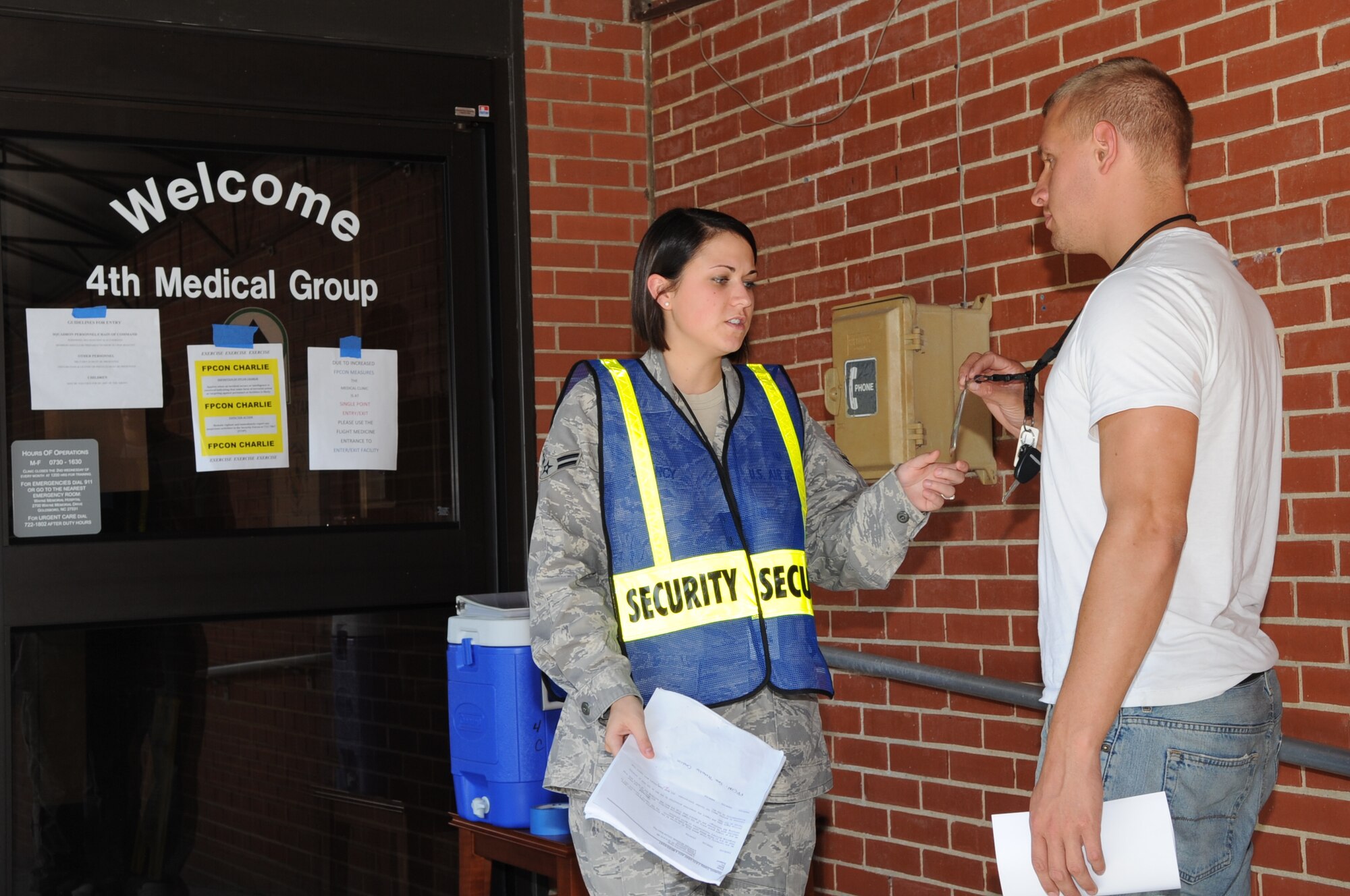SEYMOUR JOHNSON AIR FORCE BASE, N.C. -- Airman 1st Class Morgan Searcy checks the IDs of  base personnel before granting them entry to the 4th Medical Group during operational readiness exercise Coronet Warrior 10-3 here Sept. 20, 2010. Door guards are responsible for fully briefing personnel as they enter facilities on the current threat, force protection condition measures that are in place and other relevant information. Airman Searcy, a 4th Aero Medical Dental Squadron dental technician, is from Fredericks, Md. (U.S. Air Force photo/Staff Sgt. Courtney Richardson)