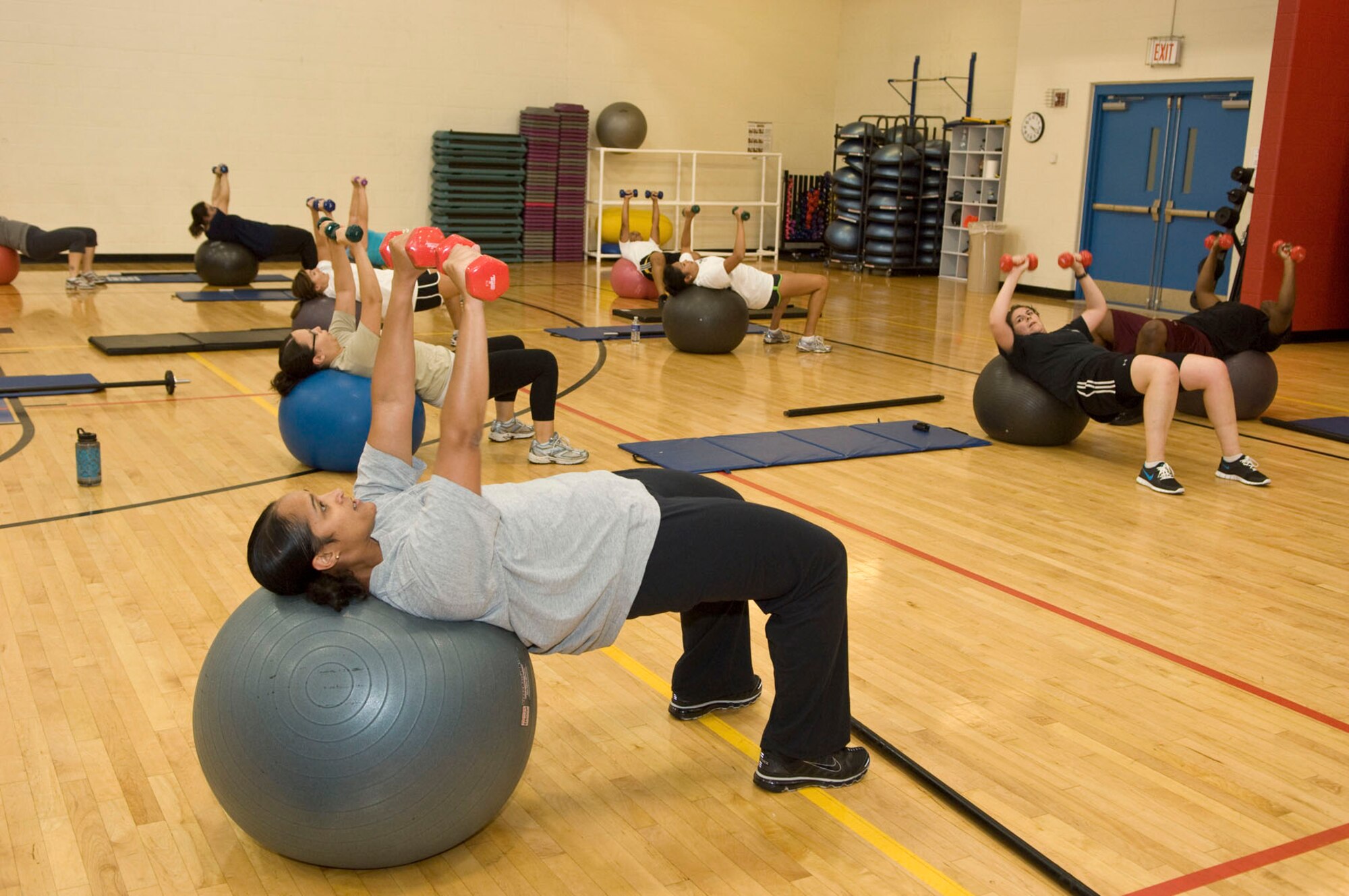 HANSCOM AIR FORCE BASE, Mass. – Master Sgt. Jamie Williams (front) leads Get Fit attendees in an exercise ball and free weight exercise on Sept. 20 at the Fitness Center. Both military and civilians gather together with Sergeant Williams on Mondays and Wednesdays from 4 to 5 p.m. to get fit. (U.S. Air Force photo by Mark Herlihy)
