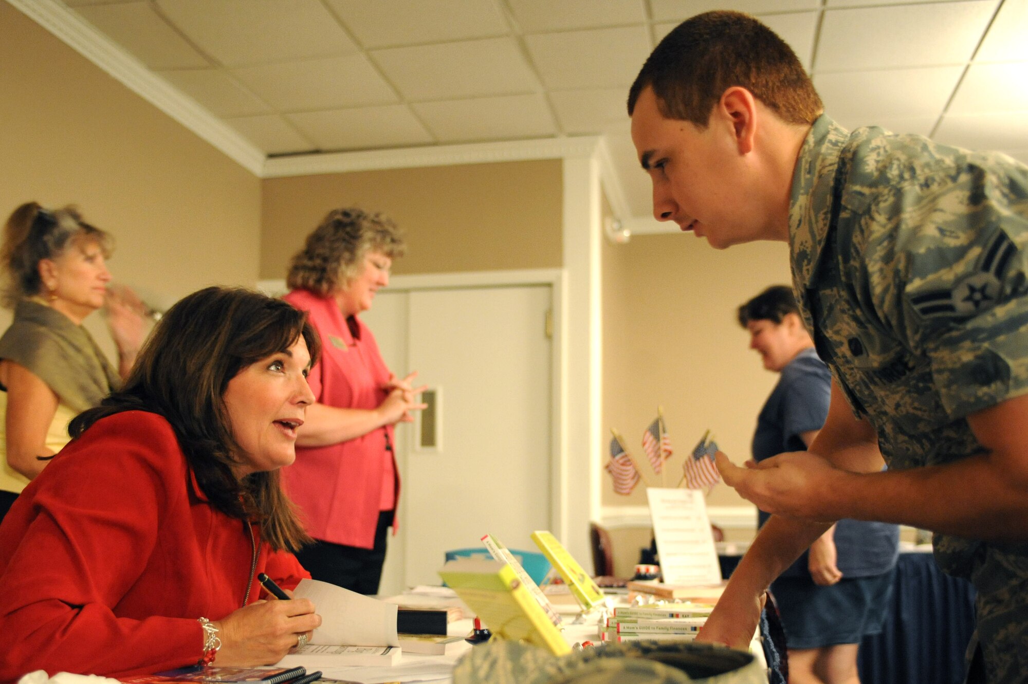 SEYMOUR JOHNSON AIR FORCE BASE, N.C. – Ellie Kay signs a copy of her book “Living Rich for Less” for Airman 1st Class Dane Gallardo after conducting two seminars on finance and military life Sept. 16, 2010. Despite being a financial advisor, Mrs. Kay had to overcome the burdens of mismanaged finances early on in her marriage to retired fighter pilot Bob Kay. Her and her husband paid off $40,000 in consumer debt, while supporting seven children on a single income. Airman Gallardo, 4th Comptroller Squadron customer service technician. (U.S. Air Force photo/Tech. Sgt. Tammie Moore)