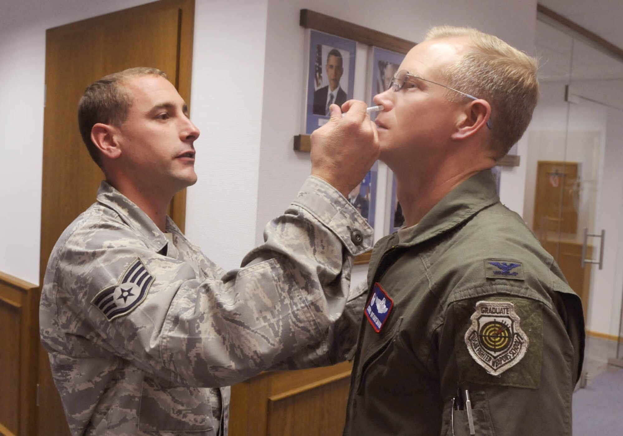 SPANGDAHLEM AIR BASE, Germany – Staff Sgt. Brian Schmit, 52nd Medical Operations Squadron, administers the influenza vaccine to Col. Christopher Weggeman, 52nd Fighter Wing commander, Sept. 22.  The vaccination, given annually to help prevent the spread of the influenza virus will be administered to approximately 10,500 Sabers.  (U.S. Air Force photo/Staff Sgt. Logan Tuttle)