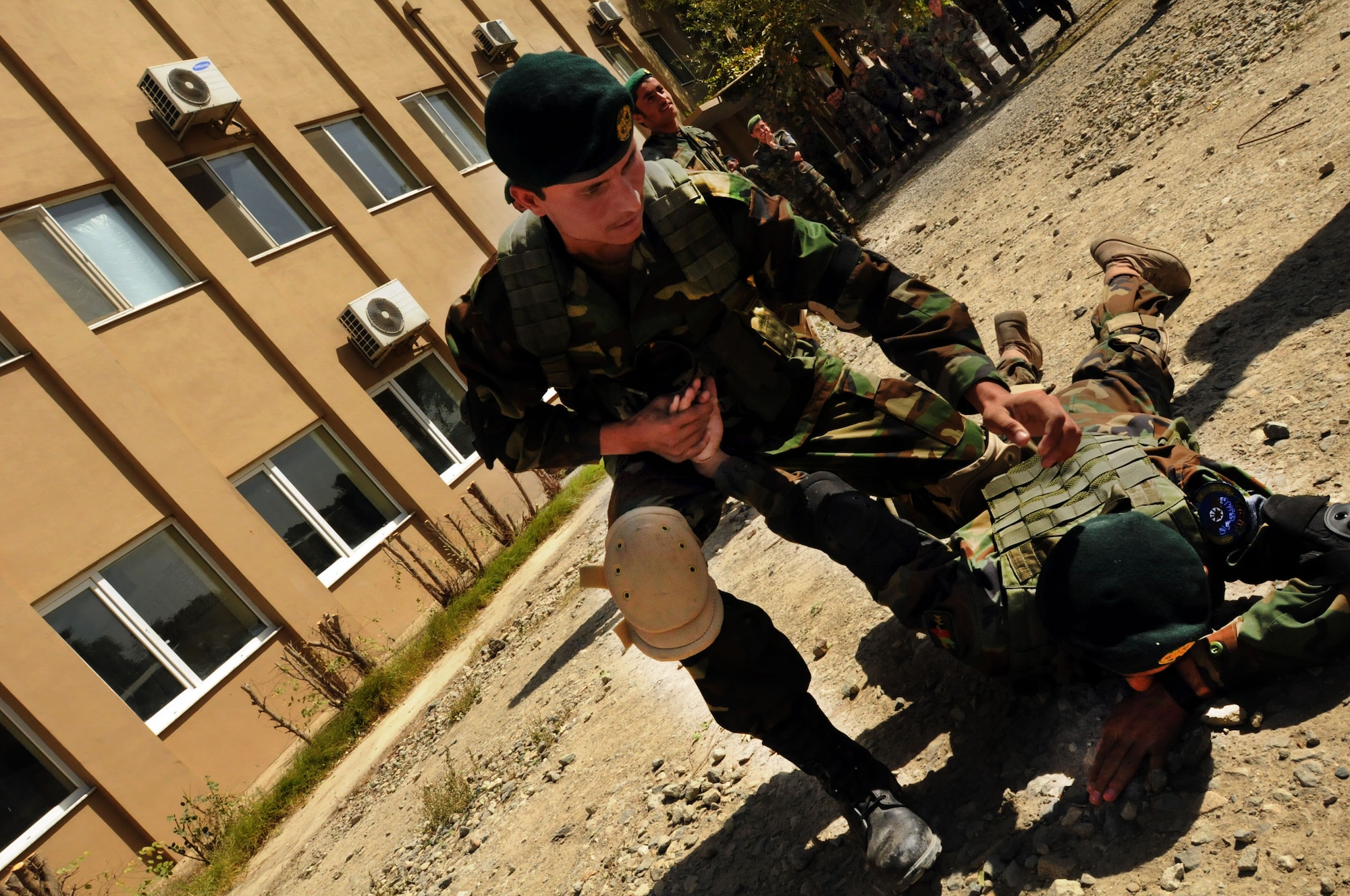100923-N-6031Q-007 KABUL, Afghanistan - Security Forces students of the Pohantoon-e-Hawayee Afghan Air Force training school practices unarmed take-downs and control method during an "open house" on Sep. 23, 2010 in which military officials were able to tour the school, peak in on courses being conducted, and were briefed on the achievements of the school over the last year. (US Navy photo by Mass Communication Specialist 2nd Class David Quillen/ RELEASED).