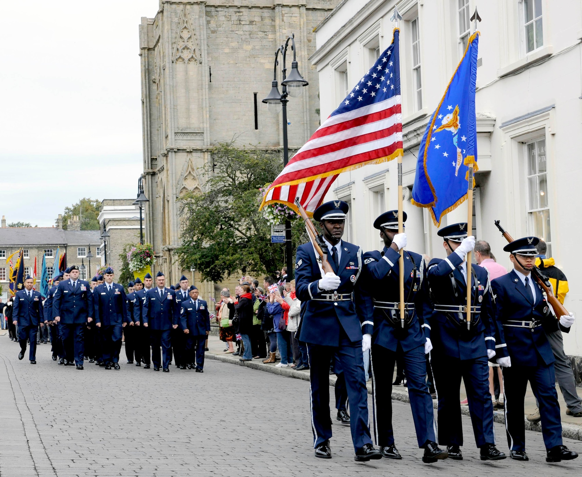 BURY ST. EDMUNDS, England -- Honor guardsmen and volunteers from RAFs Mildenhall and Lakenheath march in the Battle of Britain Parade in front of Bury St. Edmunds Cathedral Sept. 19. The parade is just one of the many events the bases participate in to help strengthen relationships with the local community. (U.S. Air Force photo/Senior Airman Ethan Morgan)
