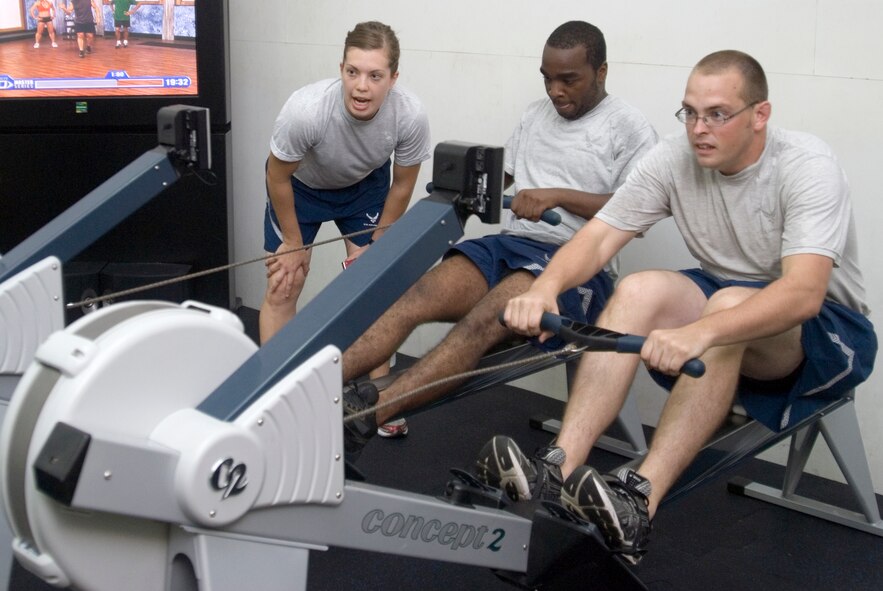 KUNSAN AIR BASE, Republic of Korea -- 1st Lt. Kari Kundert, 8th Operations Group executive officer, helps motivate members during a CrossFit workout in the brand new CrossFit/Total Resistance Exercise workout room at the base gym Sept. 21.  The CrossFit workout is built to be an intense workout that strengthens the entire body and can last anywhere from 15 to 30 minutes. (U.S. Air Force photo/Staff Sgt. Jonathan Pomeroy)