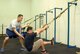 KUNSAN AIR BASE, Republic of Korea -- Staff Sgt. Chris Hart, 8th Force Support Squadron fitness director, helps guide a member through a Total Resistance Exercise workout in the brand new CrossFit/TRX workout room at the base gym Sept. 21.  Both workouts are built to strengthen the entire body and can last anywhere from 15 to 30 minutes. (U.S. Air Force photo/Staff Sgt. Jonathan Pomeroy)
