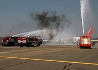 KUNSAN AIR BASE, Republic of Korea -- The 8th Civil Engineer Squadron and Republic of Korea fire departments extinguish a simulated burning aircraft as part of an exercise at the Gunsan airport here Sept. 17, 2010. The exercise is done annually to enhance counter-terrorism and prepare emergency responders for real-life situations. (U.S. Air Force photo/Senior Airman Ciara Wymbs) 