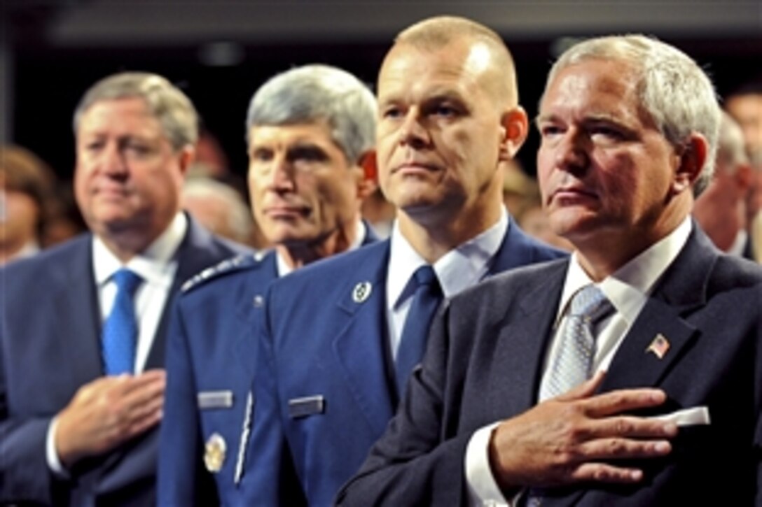 U.S. Air Force Secretary Michael Donley, far left, Air Force Chief of Staff Gen. Norton Schwartz, left, Chief Master Sgt. of the Air Force James A. Roy and Cory Etchberger, son of Medal of Honor recipient Chief Master Sgt. Richard L. Etchberger, stand during the playing of the national anthem at the Pentagon Hall of Heroes induction ceremony to honor Etchberger at the Pentagon, Sept. 22, 2010.
