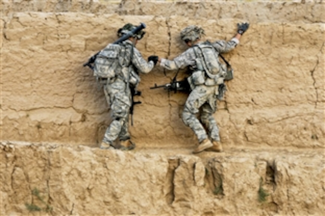 U.S. Army Sgt. Sharanjit Dhaliwal helps one of his soldiers across a narrow path during a presence patrol in Zabul province, Afghanistan, Sept. 18, 2010. Dhaliwal is assigned to the 1st Battalion, 4th Infantry Regiment.
