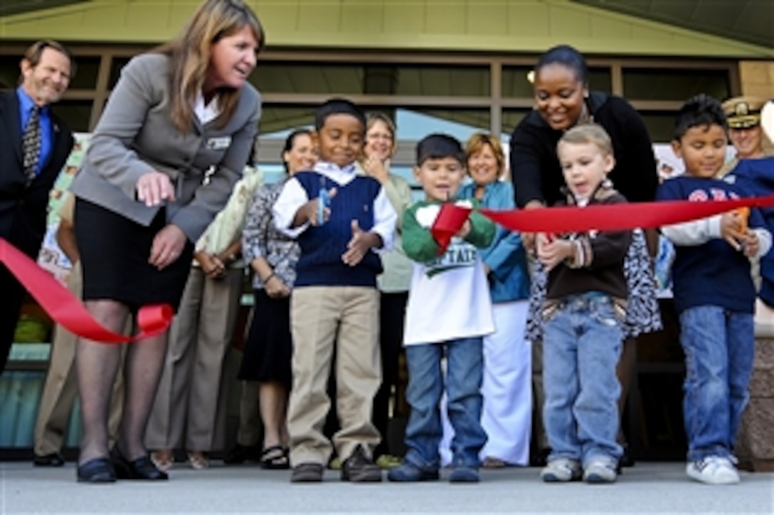 Children cut a red ribbon to mark the opening of the Child Development Center on Naval Base San Diego, Calif., Sept. 22, 2010. The 31,200 square-foot building will house a program offering care for the children of servicemembers.