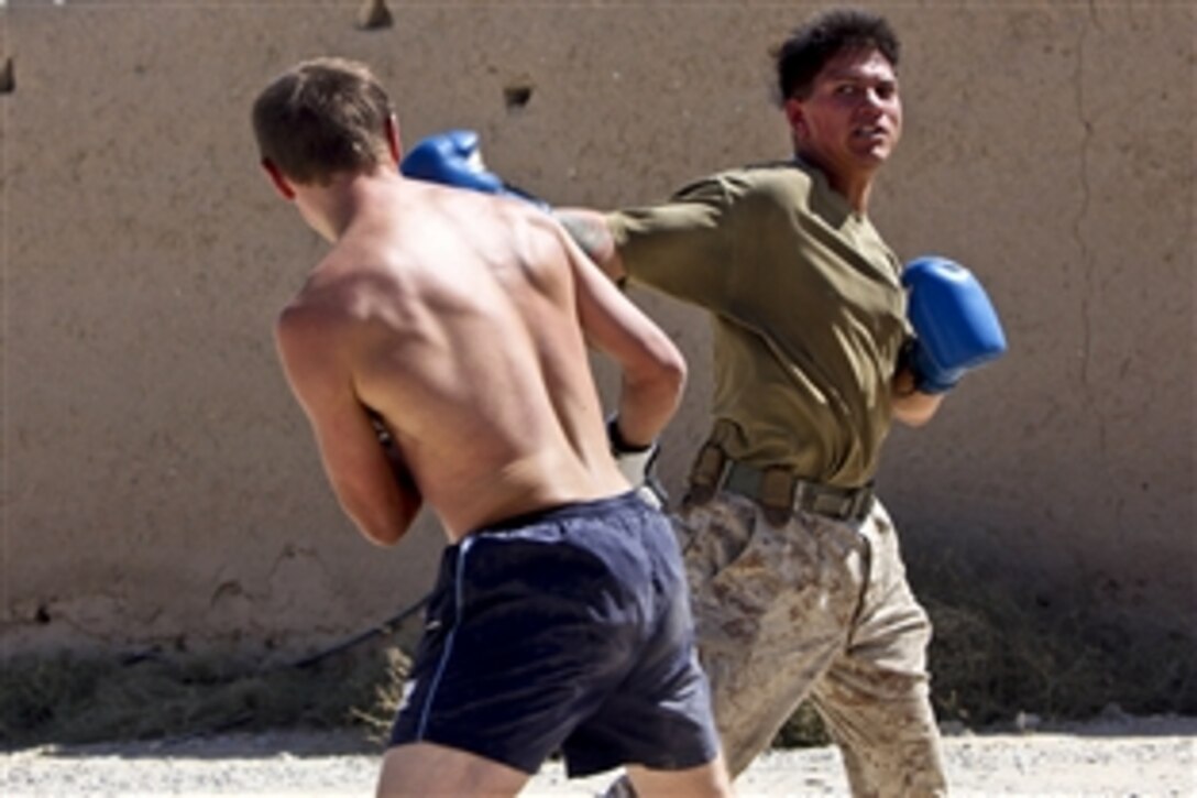 U.S. Marine Corps Staff Sgt. Francisco Martinez throws a hook at British Royal Marines Capt. Mark O’Sullivan during a boxing match on Forward Operating Base Jackson in Afghanistan's Helmand province, Sept. 22, 2010. The boxing bout was an opportunity for U.S. and U.K. marines to train together. Martinez is a platoon sergeant assigned to Lima Company, 3rd Battalion, 7th Marine Regiment, and O'Sullivan is a company commander.