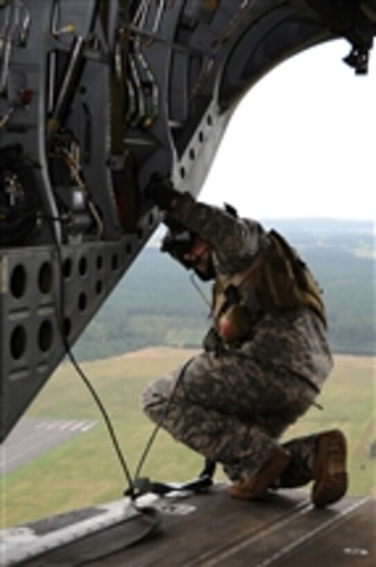 A U.S. Army crew chief from the 160th Special Operations Aviation Regiment (Airborne) checks a landing zone from the ramp of an MH-47G Chinook helicopter during the opening ceremonies of Jackal Stone 10 in Swidwin, Poland, on Sept. 20, 2010.  Jackal Stone 10, hosted by Poland and Lithuania, is a special operations exercise designed to enhance capabilities and interoperability among the participating forces and to build mutual respect while sharing doctrinal concepts.  The exercise, which was coordinated with U.S. Special Operations Command Europe, included Poland, Lithuania, Latvia, Croatia, Romania and Ukraine.  