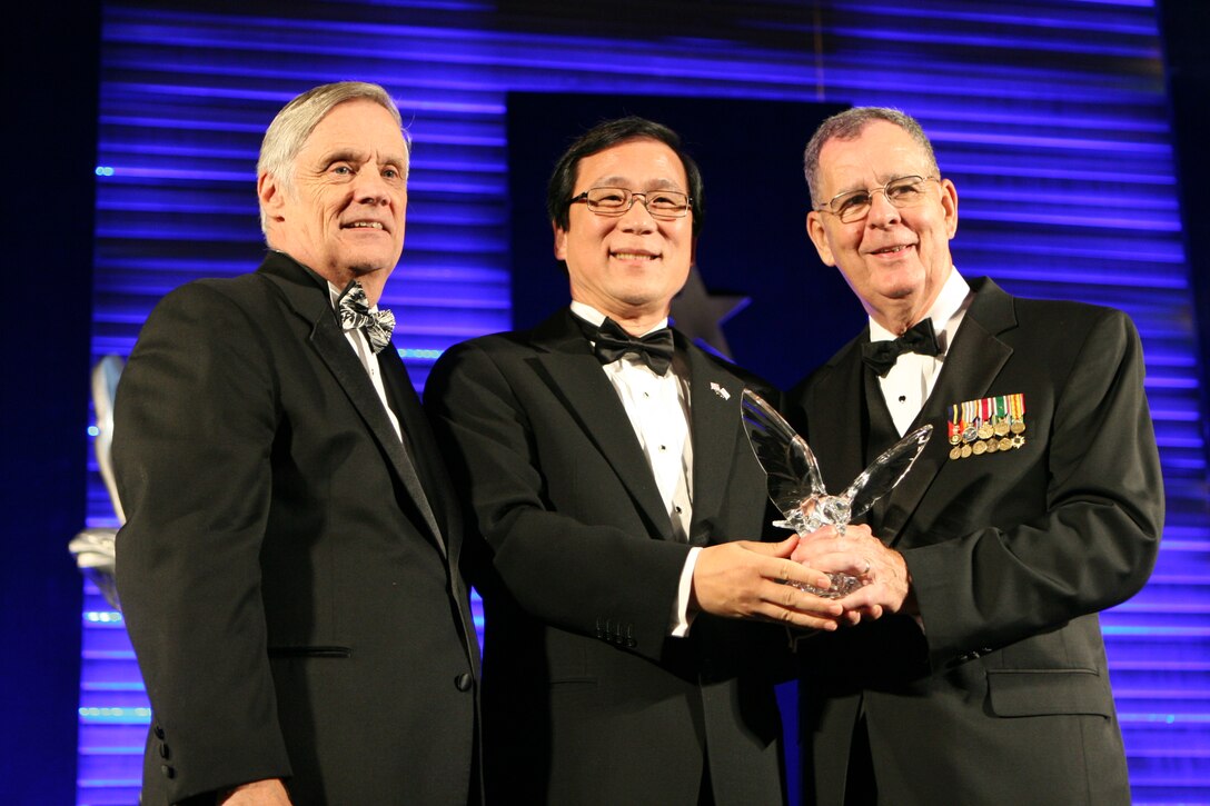 Mayor of Irvine, Calif.,Sukhee Kang, poses for a photo with Assistant Secretary of Defense for Reserve Affairs, Dennis McCarthy, and principal financial advisor to Robert Gates, Robert F. Hale during the Employer and Support of the Guard and Reserve’s Freedom Award Ceremony at the Ronald Reagan Center in the nation’s capital.