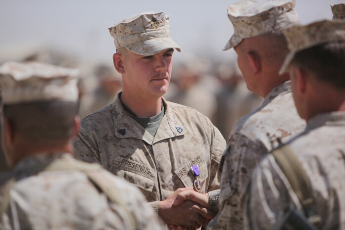 Sergeant David Fresenius, an assistant team leader with 3rd Platoon, Bravo Company, 1st Reconnaissance Battalion, is awarded the Purple Heart by Brig. Gen. Joseph Osterman, 1st Marine Division (Forward) commanding general, aboard Camp Leatherneck, Sept. 23. The 23-year-old from Westminster, Calif., was hit in the top of his back’s protective Sapi plate during a small arms fire engagement in Trek Nawa, on June 21, 2010.  The round lodged in his protective gear, just millimeters away from breaking skin and hitting his upper spine.  After his corpsman attended to the wound, that left a baseball-sized welt in his upper back, a very lucky and determined Fresenius re-donned his gear, and got back in the engagement with the Taliban that lasted just over an hour. “It felt like I had been hit with a sledge hammer,” Fresenius said.  “Once I realized I was okay, my only thoughts were to get back to the fight – to get back with my men.”