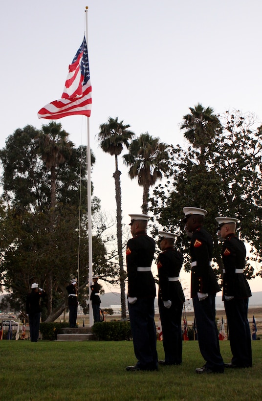 A Camp Pendleton color guard salutes the American flag during an evening colors ceremony at Camp Pendleton’s historic Santa Margarita Ranch House, Sept. 23. The ceremony marked the base’s 68th anniversary and was dedicated to recognize the Marines and sailors who continue to devote and risk their lives for the freedom of the United States.