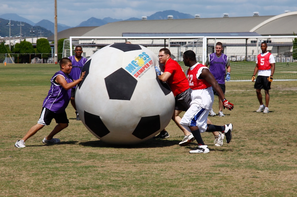 Participants with Combat Logistics Company 36 and Marine Wing Support Squadron 171 battle for possession of a nearly six-foot tall soccer ball during the second to last Commander’s Cup Challenge called Earthball at the Penny Lake soccer fields here Sept. 24.
