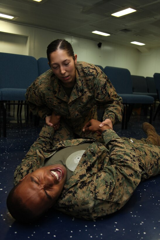 Staff Sgt. Leah G. Dorley, native of Hazel Park, Mich., and embarkation chief with Marine Air Control Squadron 2, checks the pulse of Sgt. Xavier W. Wethington, a simulated casualty and native of Brunswick, Ga., during a casualty assessment test of the Combat Life Saver training aboard the USS Iwo Jima, Sept. 24, 2010. Marines with MACS-2, Command Element of Special-Purpose Marine Air-Ground Task Force Continuing Promise 2010 participated in the five-day training while operating off the coast of Bluefields, Nicaragua, during their four-month deployment to the Caribbean, Central and South America.