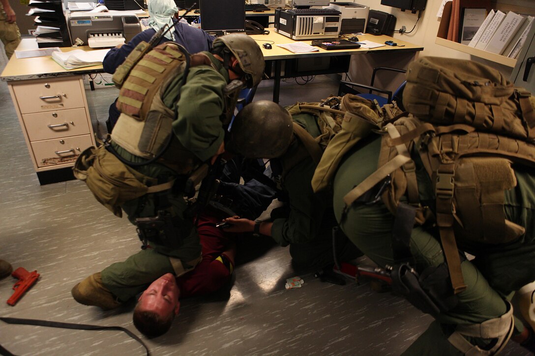 U.S. Marines with the Maritime Raid Force, 31st Marine Expeditionary Unit (MEU), detain a simulated adversary during a Visit, Board, Search, and Seizure (VBSS) exercise aboard the U.S. Navy Ship Alan Shepard in support of a certification exercise conducted by the 31st MEU.