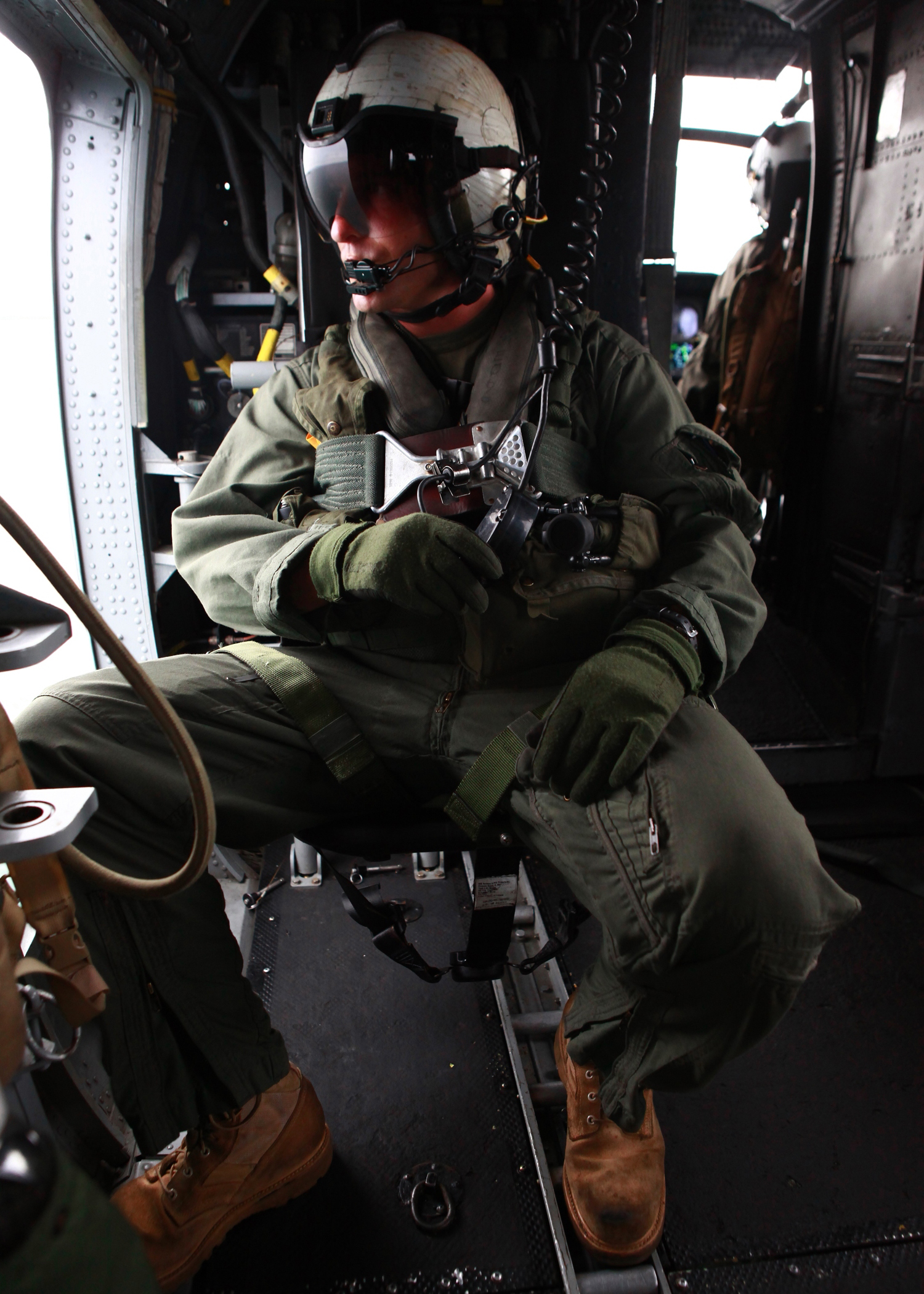 A U.S. Marine with Marine Medium Helicopter Squadron (HMM) 774, attached to Special-Purpose Marine Air-Ground Task Force Continuing Promise 2010 (CP10), provides aircrew support aboard a CH-46E Sea Knight helicopter, while transporting leaders to the closing ceremony of humanitarian assistance and subject-matter expert exchanges, in Bluefields, Nicaragua, Sept. 24, 2010. Service members and civilians are deployed in support of CP10 providing medical, dental, veterinary, engineering assistance and subject-matter exchanges to the Caribbean, Central and South America. (U.S. Marine Corps photo by Sgt. Samuel R. Beyers/Released)