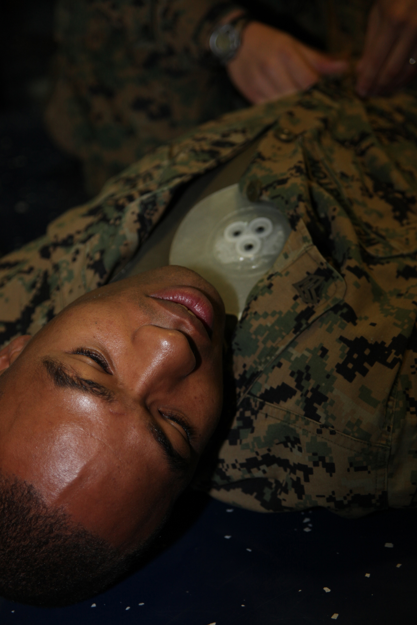 Sgt. Xavier W. Wethington, native of Brunswick, Ga., and air-traffic control specialist with Marine Air Control Squadron 2, simulates a casualty with a sucking chest wound during a casualty assessment test of the Combat Life Saver training aboard the USS Iwo Jima, Sept. 24, 2010. Marines with MACS-2, Command Element of Special-Purpose Marine Air-Ground Task Force Continuing Promise 2010 participated in the five-day training while operating off the coast of Bluefields, Nicaragua, during their four-month deployment to the Caribbean, Central and South America.
