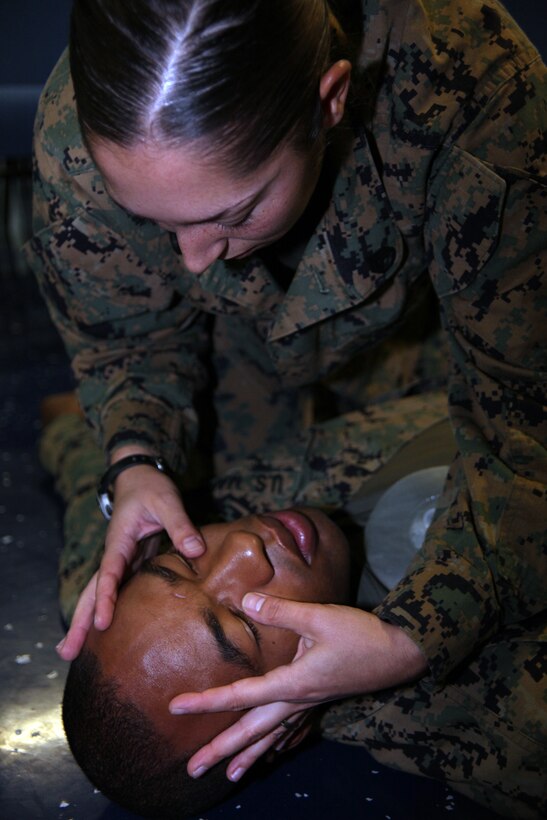 Staff Sgt. Leah G. Dorley, native of Hazel Park, Mich., and embarkation chief with Marine Air Control Squadron 2, checks for head injuries on Sgt. Xavier W. Wethington, a simulated casualty and native of Brunswick, Ga., during a casualty assessment test of the Combat Life Saver training aboard the USS Iwo Jima, Sept. 24, 2010. Marines with MACS-2, Command Element of Special-Purpose Marine Air-Ground Task Force Continuing Promise 2010 participated in the five-day training while operating off the coast of Bluefields, Nicaragua, during their four-month deployment to the Caribbean, Central and South America.