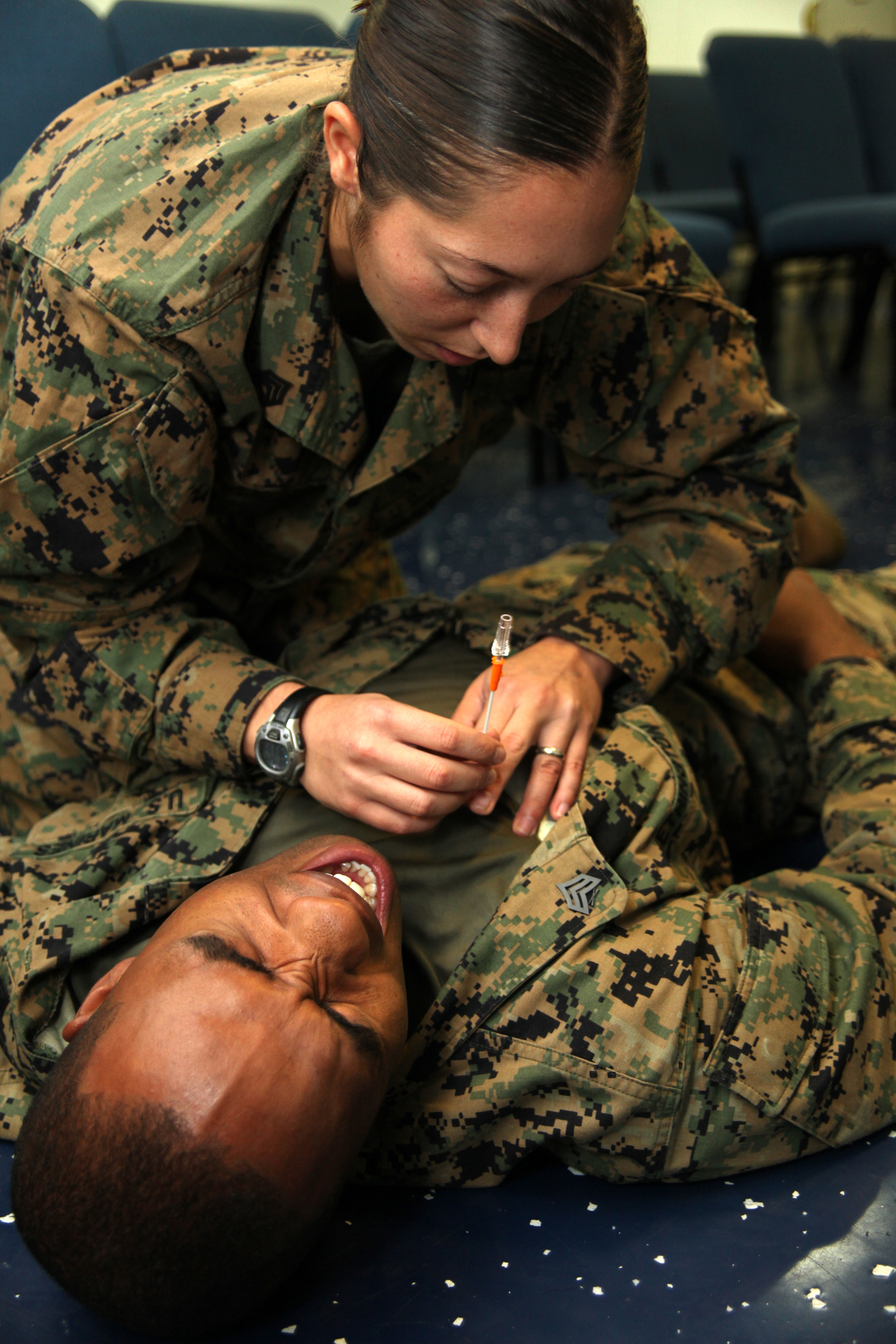 Staff Sgt. Leah G. Dorley, native of Hazel Park, Mich., and embarkation chief with Marine Air Control Squadron 2, simulates applying a needle thoracentesis to Sgt. Xavier W. Wethington, a simulated casualty and native of Miami, Fla., during a casualty assessment test of the Combat Life Saver training aboard the USS Iwo Jima, Sept. 24, 2010. Marines with MACS-2, Command Element of Special-Purpose Marine Air-Ground Task Force Continuing Promise 2010 participated in the five-day training while operating off the coast of Bluefields, Nicaragua, during their four-month deployment to the Caribbean, Central and South America.